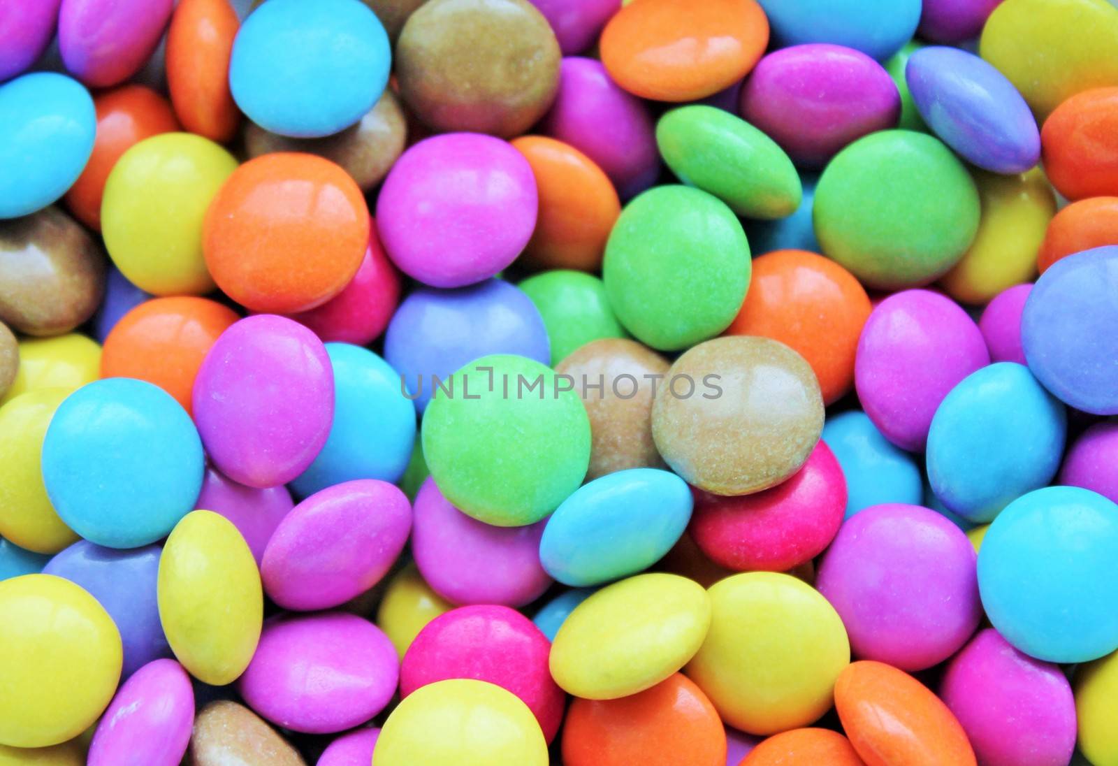 hard Colored candy smarties texture pattern background by cheekylorns