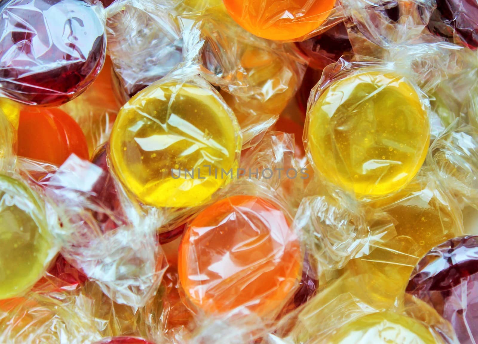 full screen Close up on colorful boiled sweets. by cheekylorns