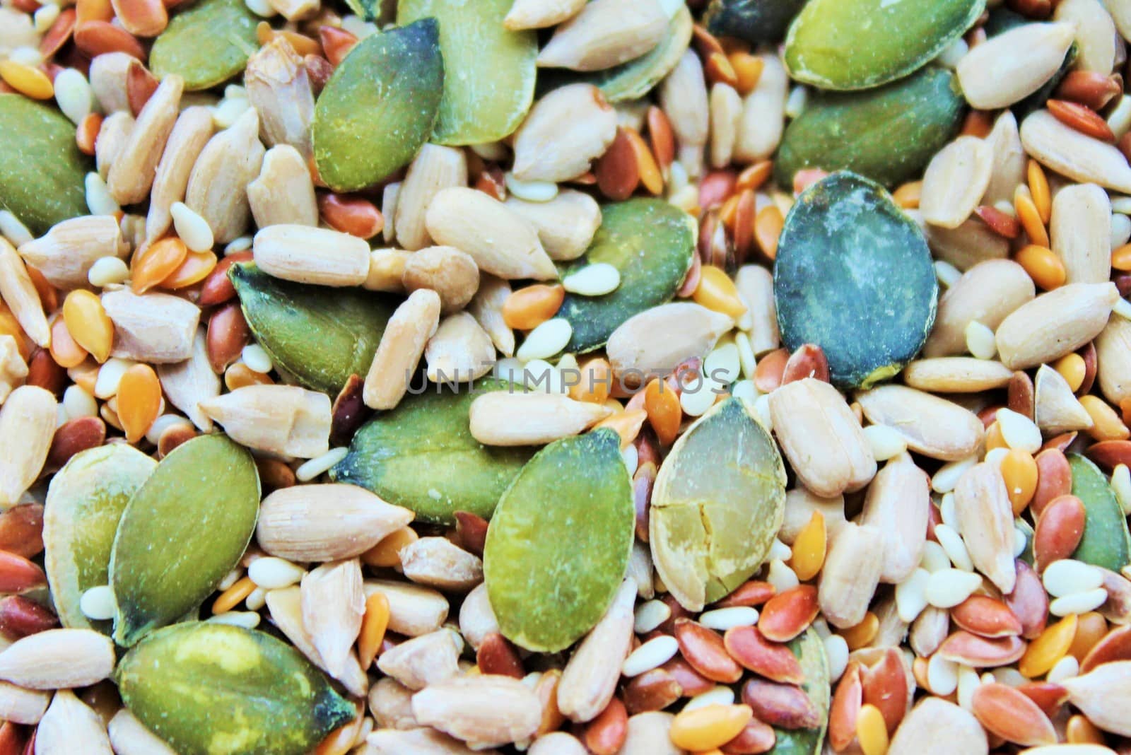 Background made of row healthy organic grain food mixed: sesame, flax, buckwheat, wheat, pumpkin seeds, sunflower seeds by cheekylorns