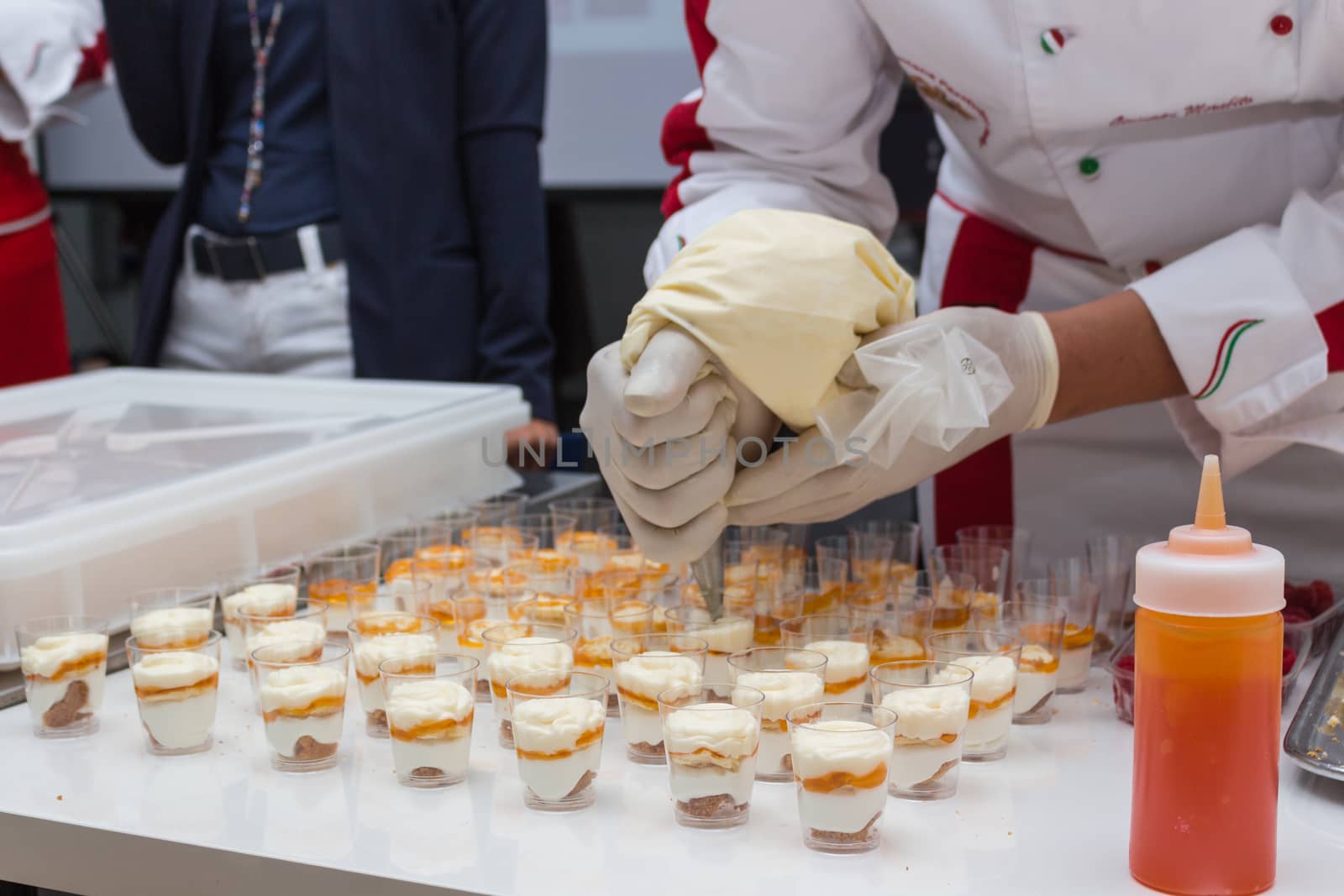 pastry chef is decorating a dessert