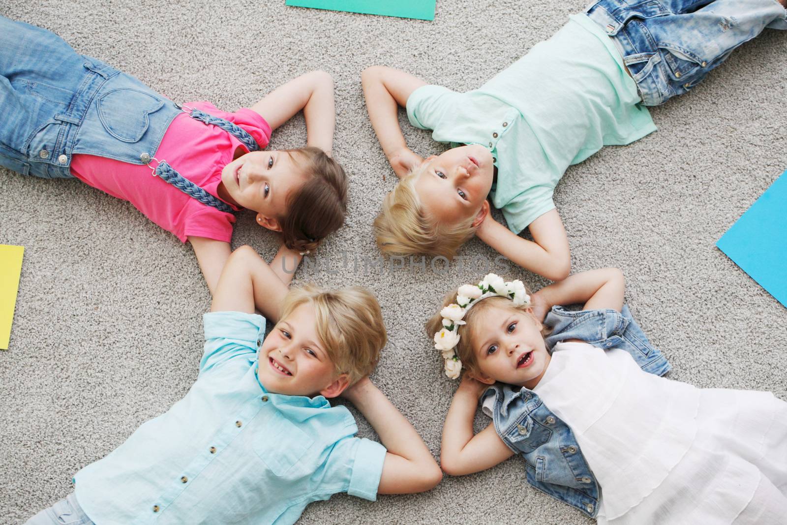 happy kids lying on the floor at home