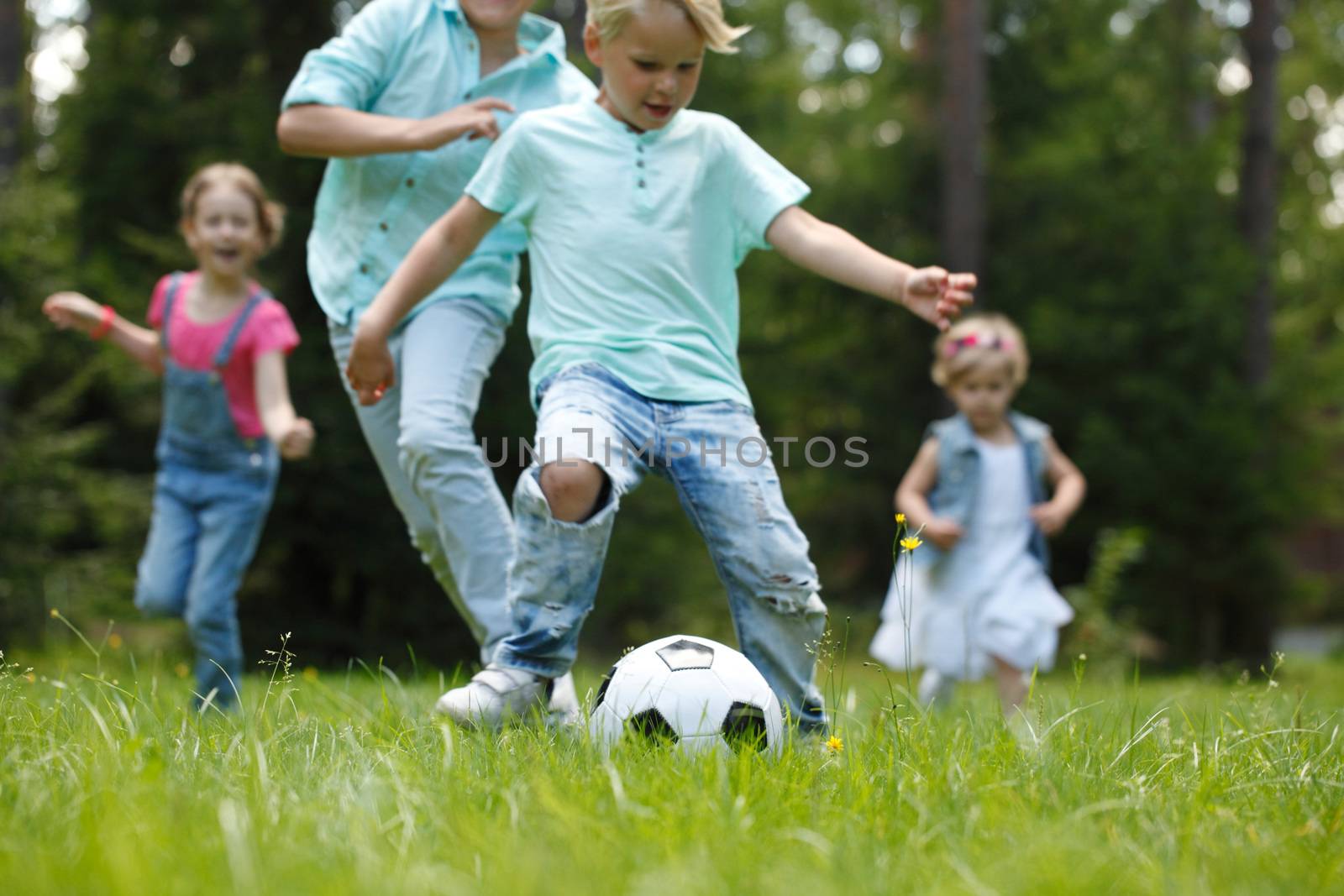 kids playing football by ALotOfPeople