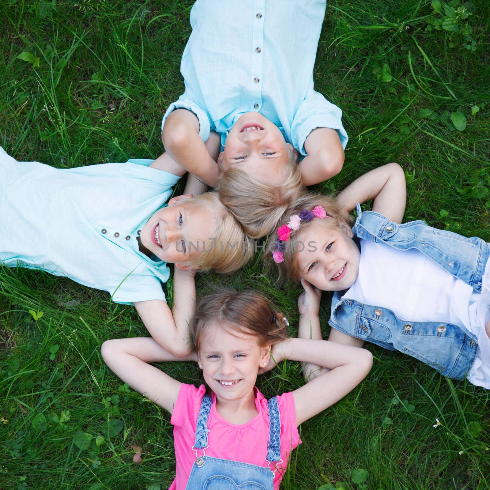 group of kids lying on grass