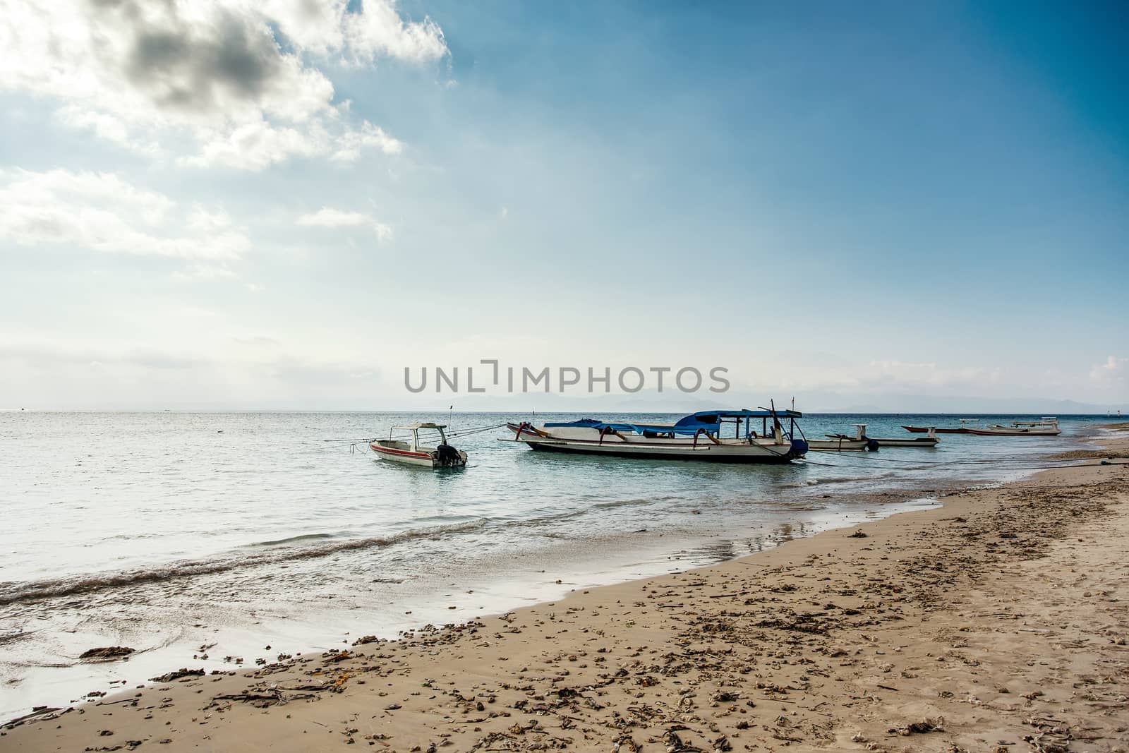 dream sand beach with boat, Bali Indonesia, Nusa Penida island with dramatic blue sky