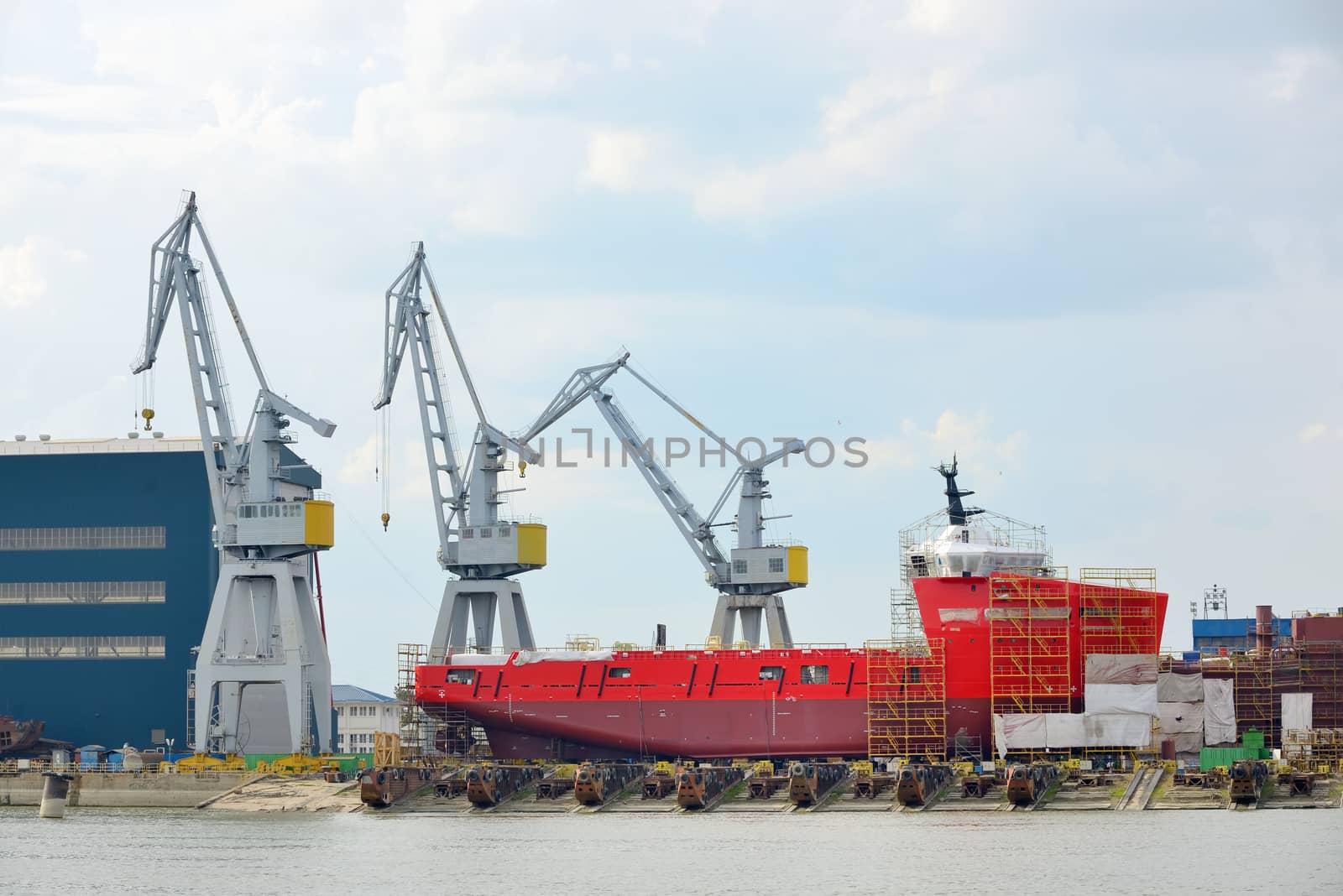 Ship being constructed and cranes