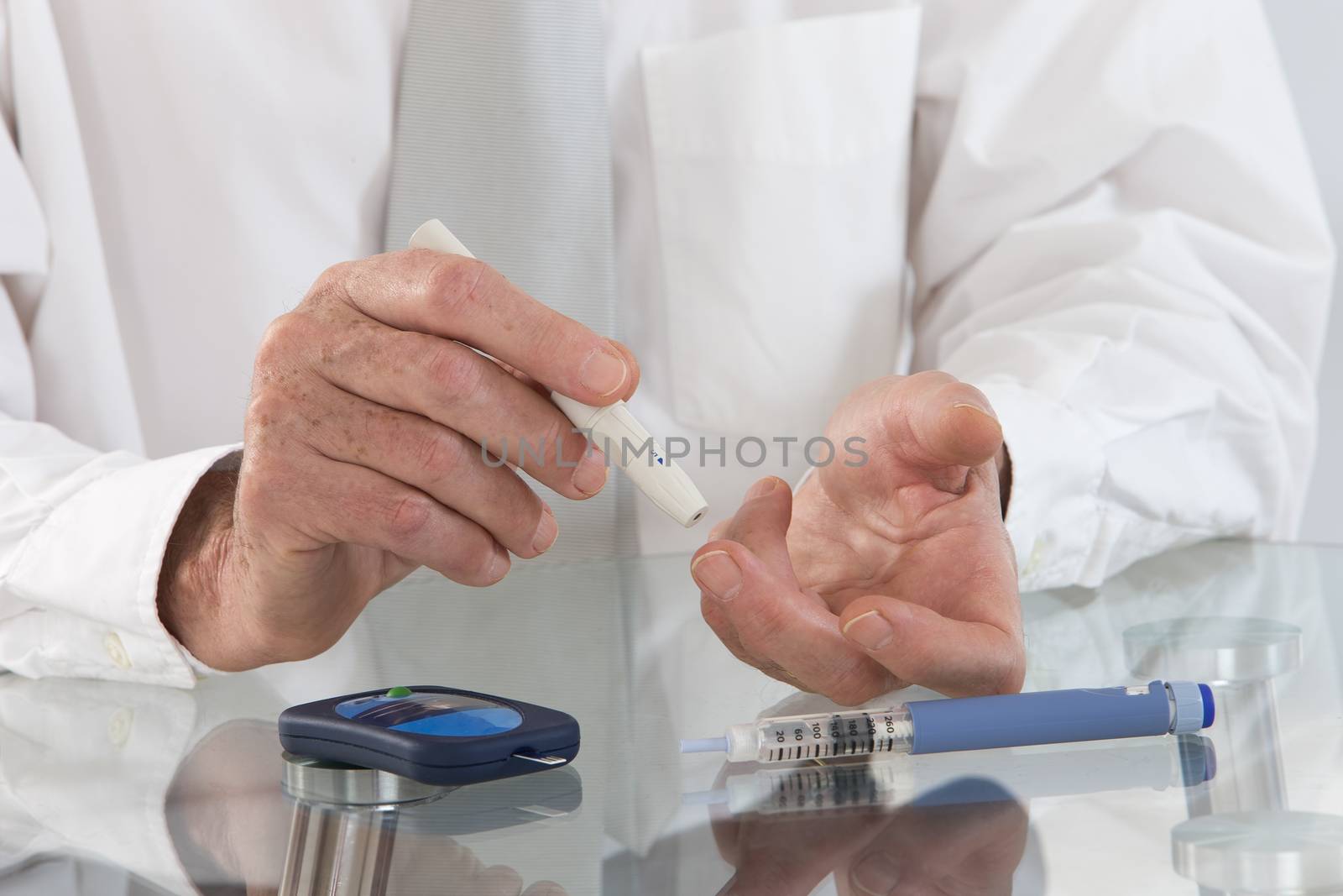 Business man in his office  with  onset diabetes measuring blood sugar with indicator