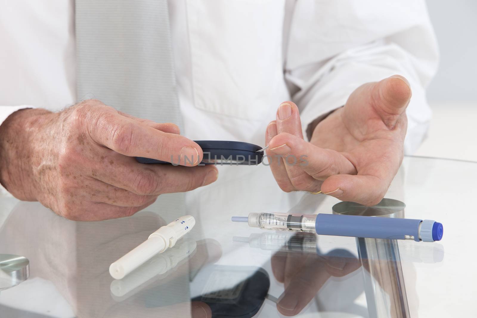 Business man in his office  with  onset diabetes measuring blood sugar with indicator