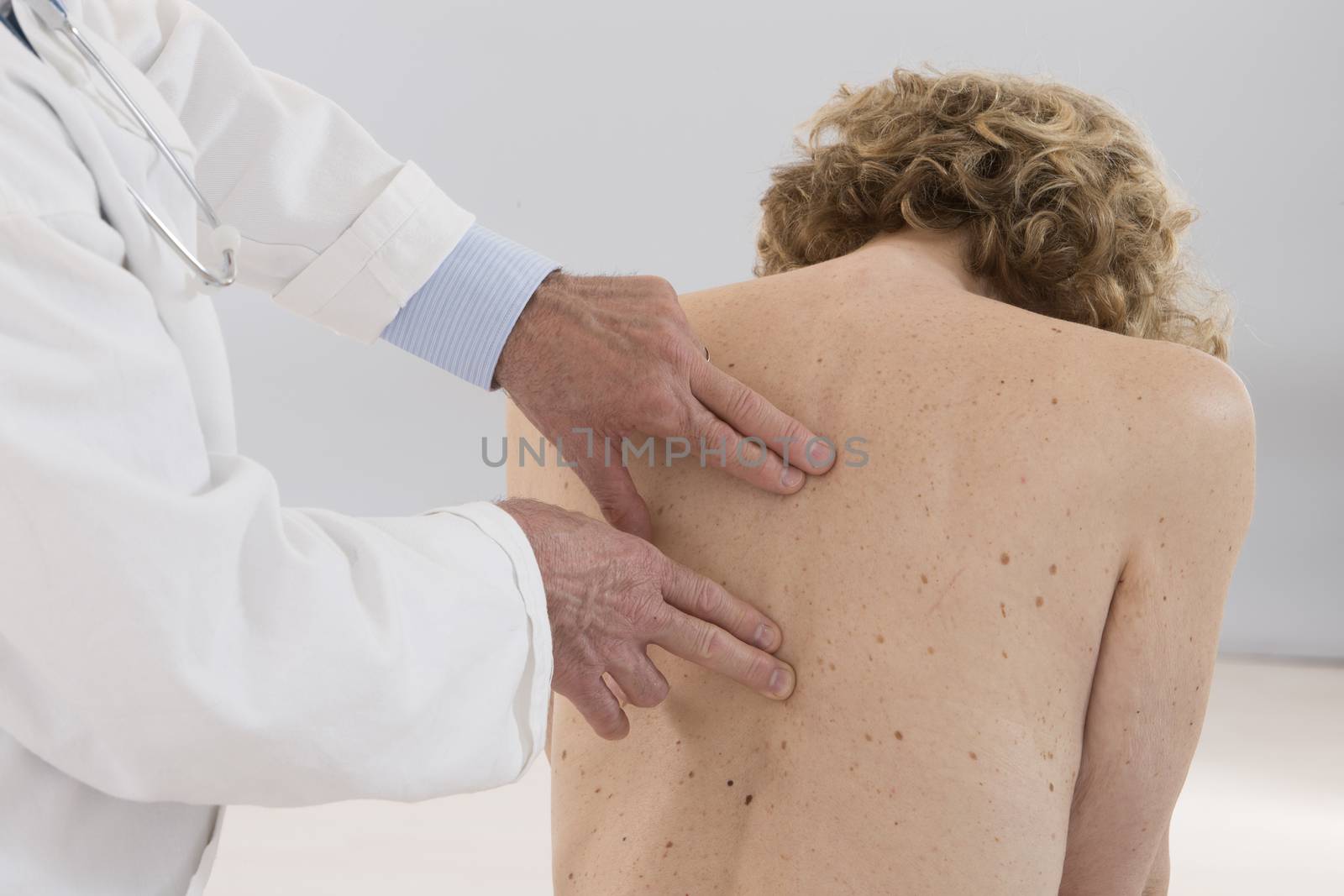 Chiropractor massage the female patient spine and back