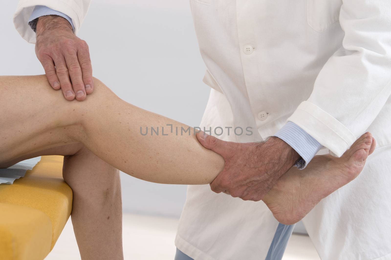 knee examination doctor therapist to woman patient in hospital