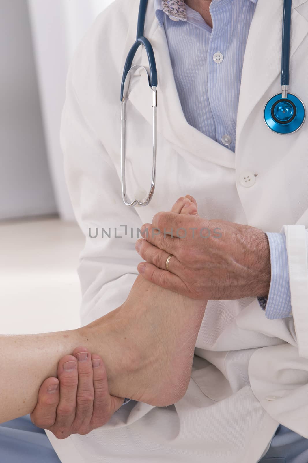 Ankle and Foot examination doctor to woman patient in hospital by JPC-PROD