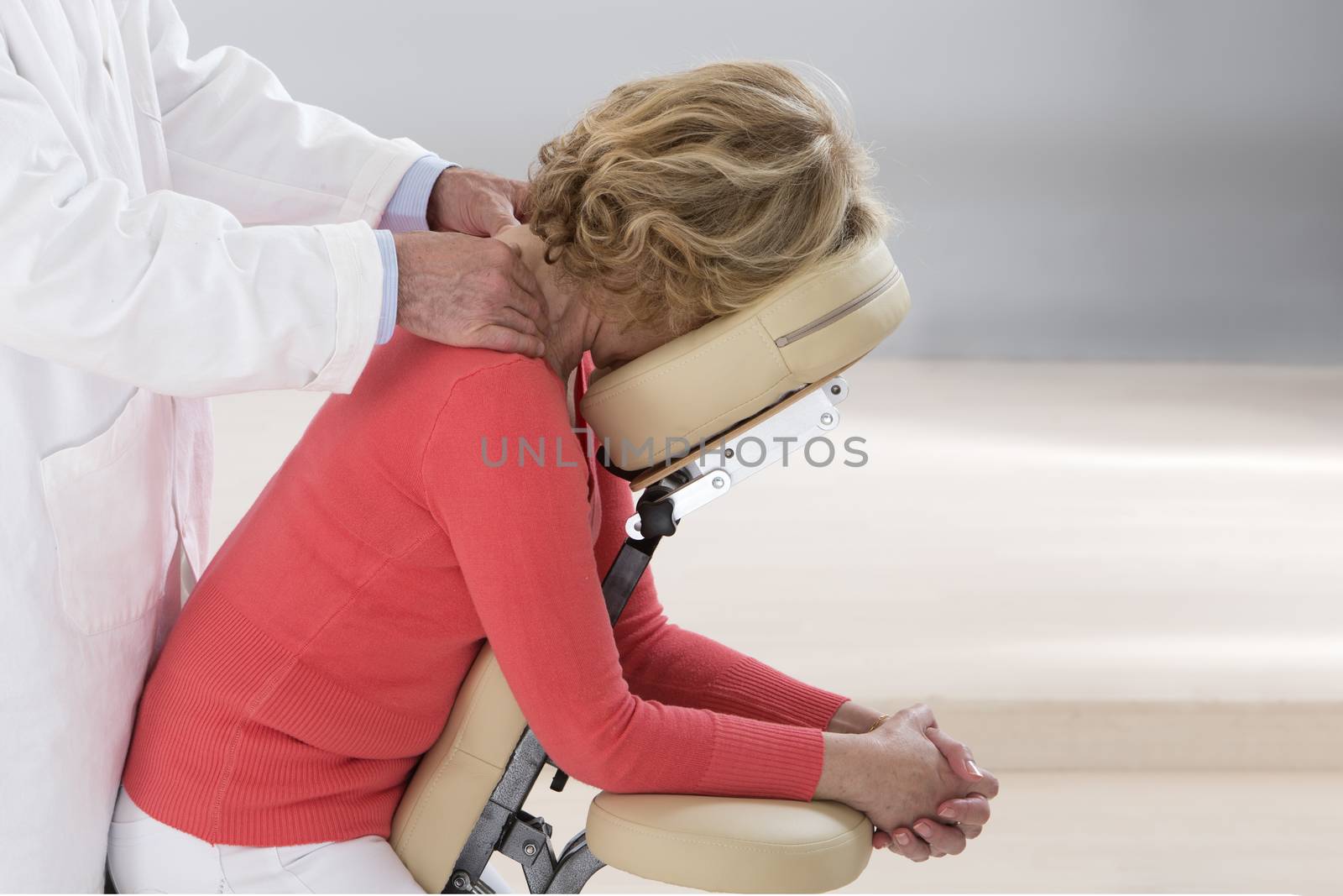 Woman seated in a massage chair for back massage