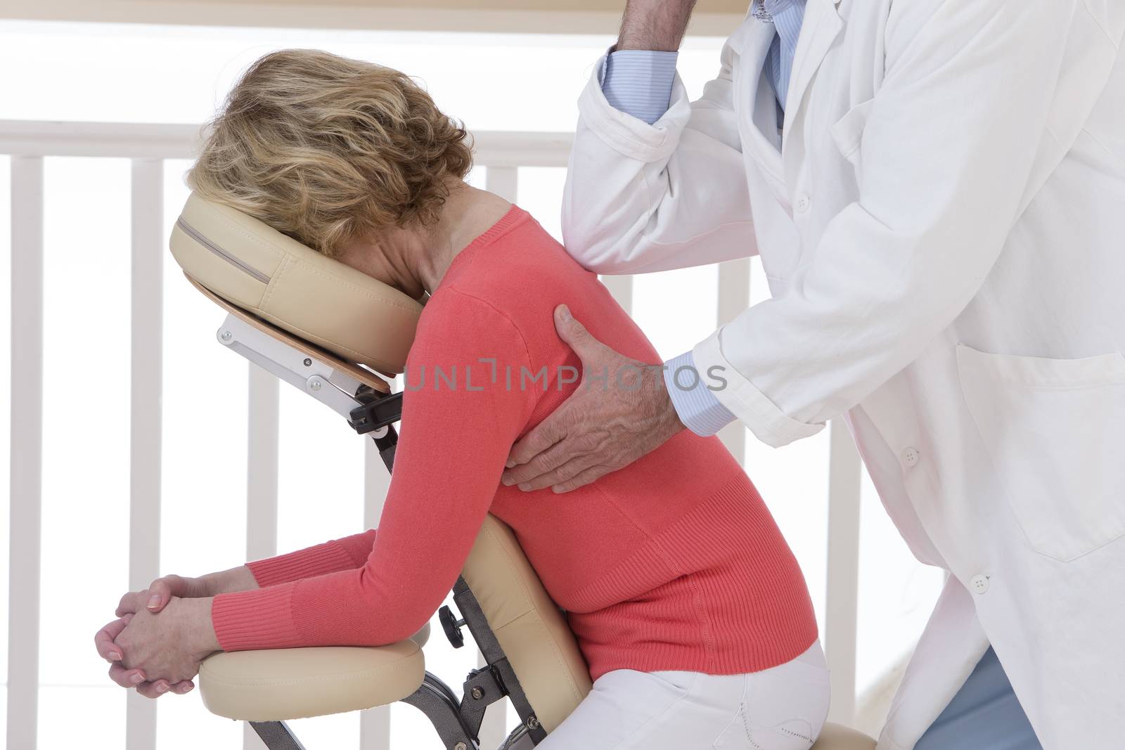 Woman seated in a massage chair for back massage