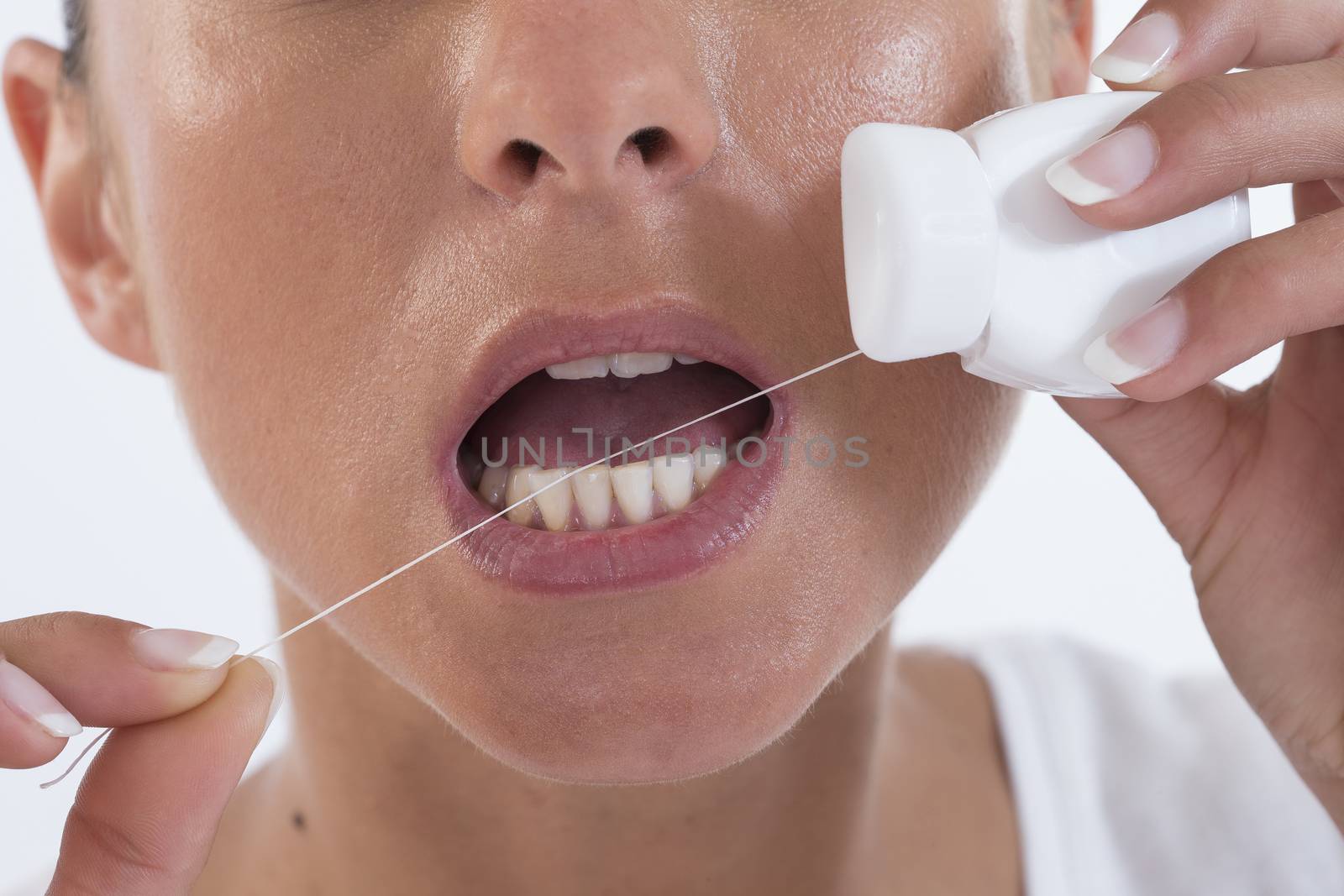 Close up of mouth and dental floss in the white background