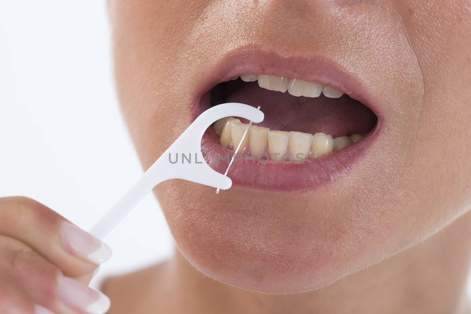 Close up of mouth and dental floss in the white background
