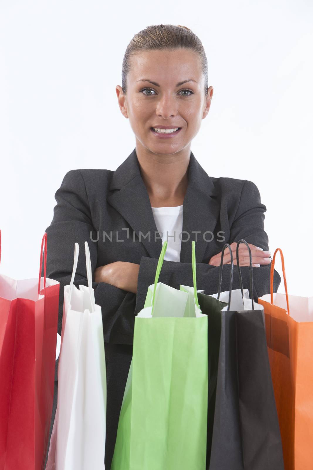 Young beautiful shopping woman during sale holding many colorful by JPC-PROD