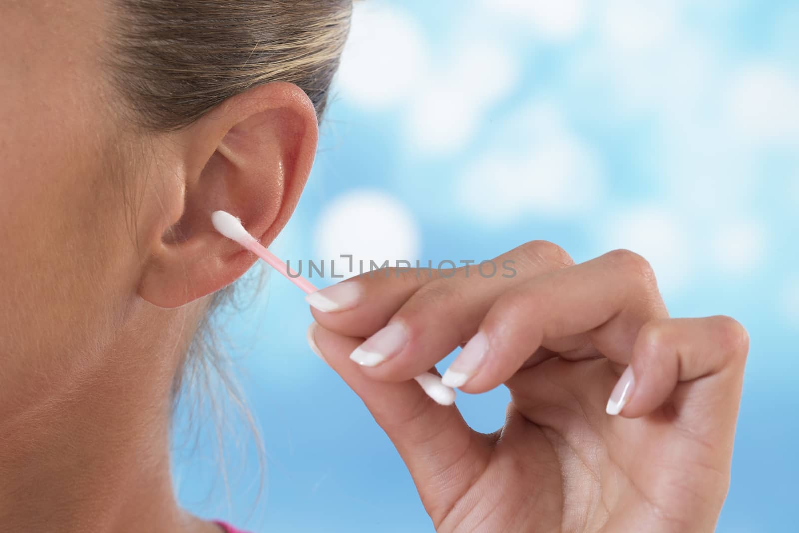 Female person using cotton stick