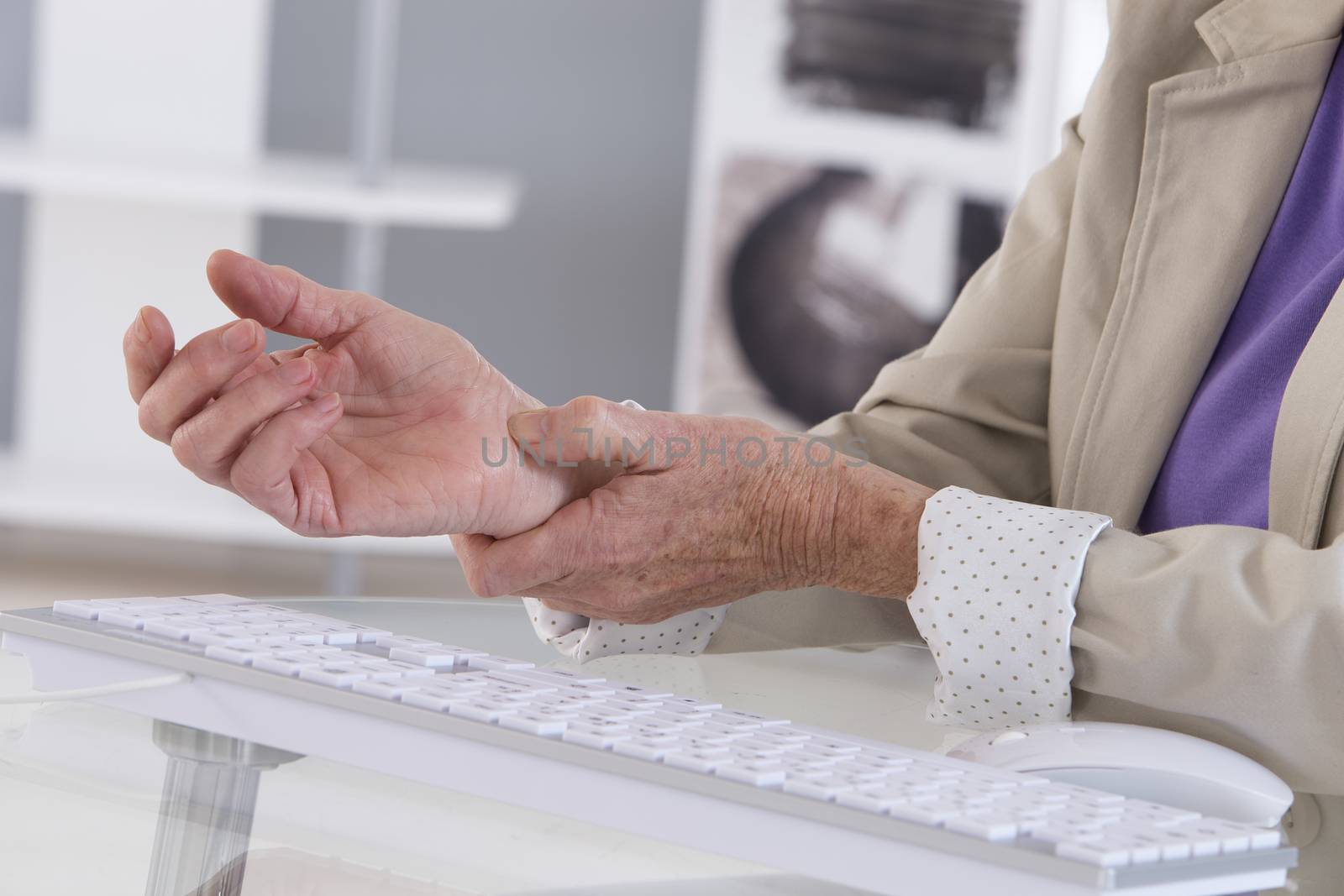 Hands with RSI syndrome over the keyboard of laptop computer