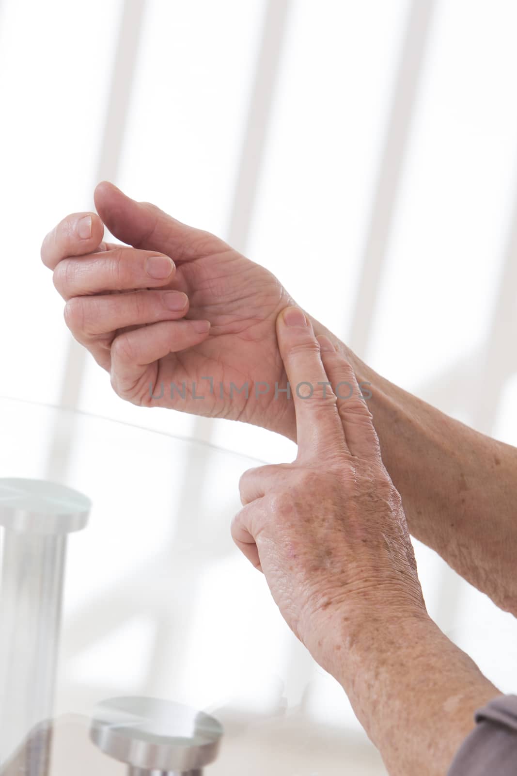 senior woman hand measuring her own arm pulse by JPC-PROD