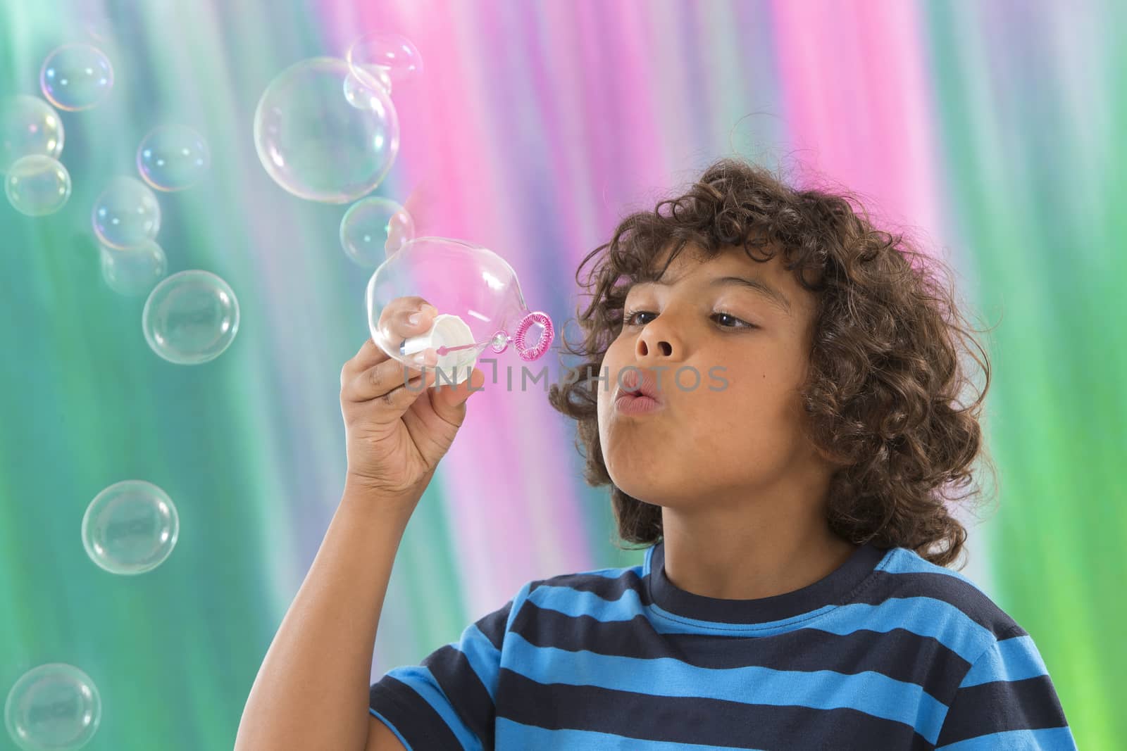 Child blowing a soap bubbles.  by JPC-PROD