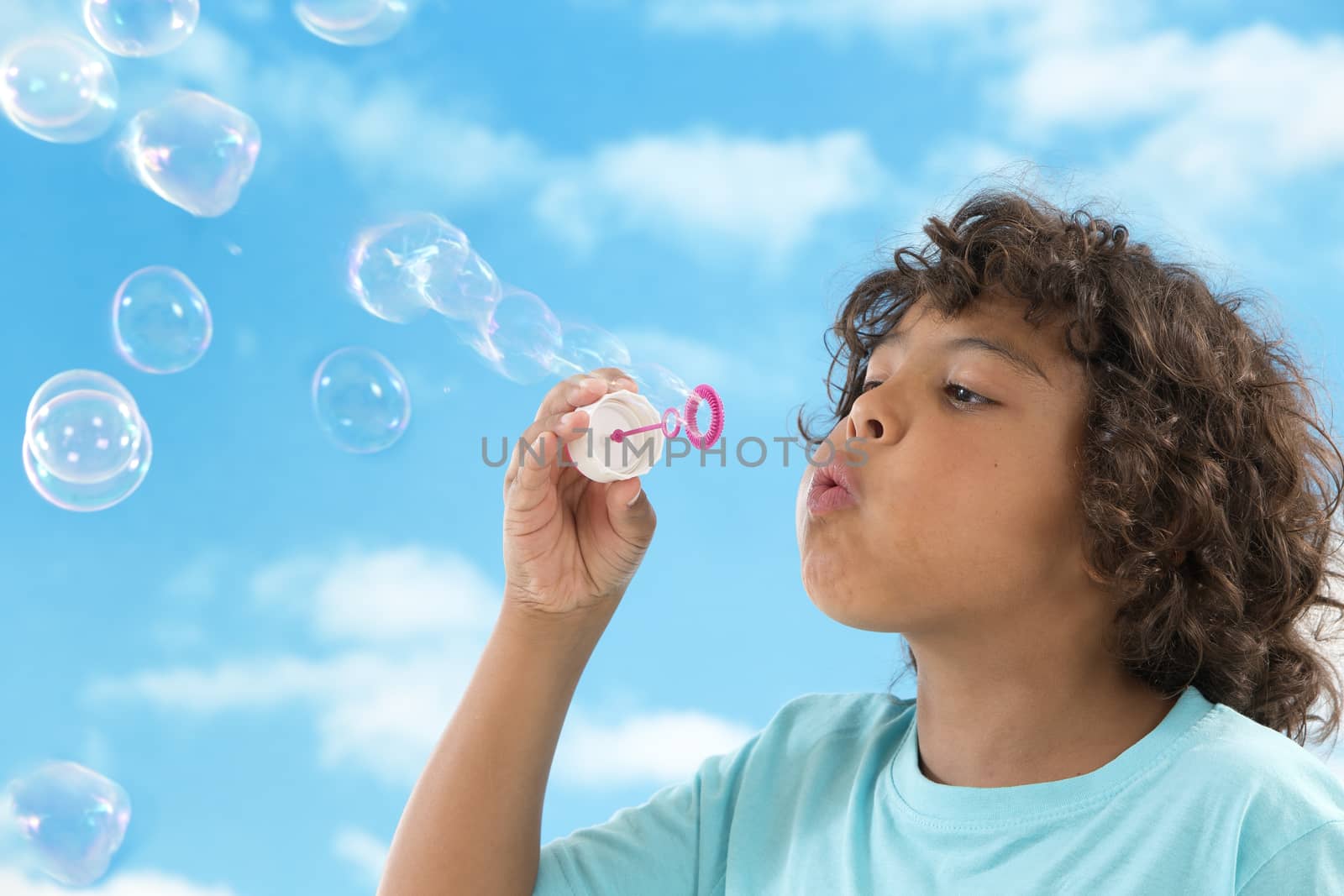 Boy blows up soap bubbles