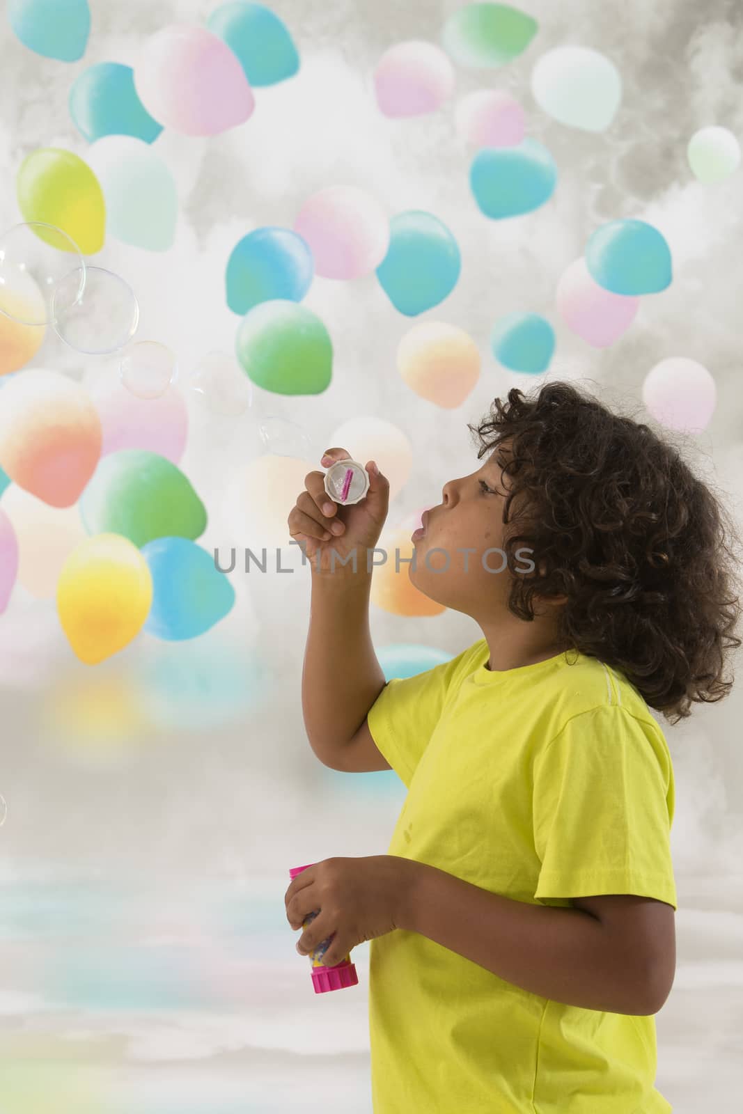 Child blowing a soap bubbles.  by JPC-PROD