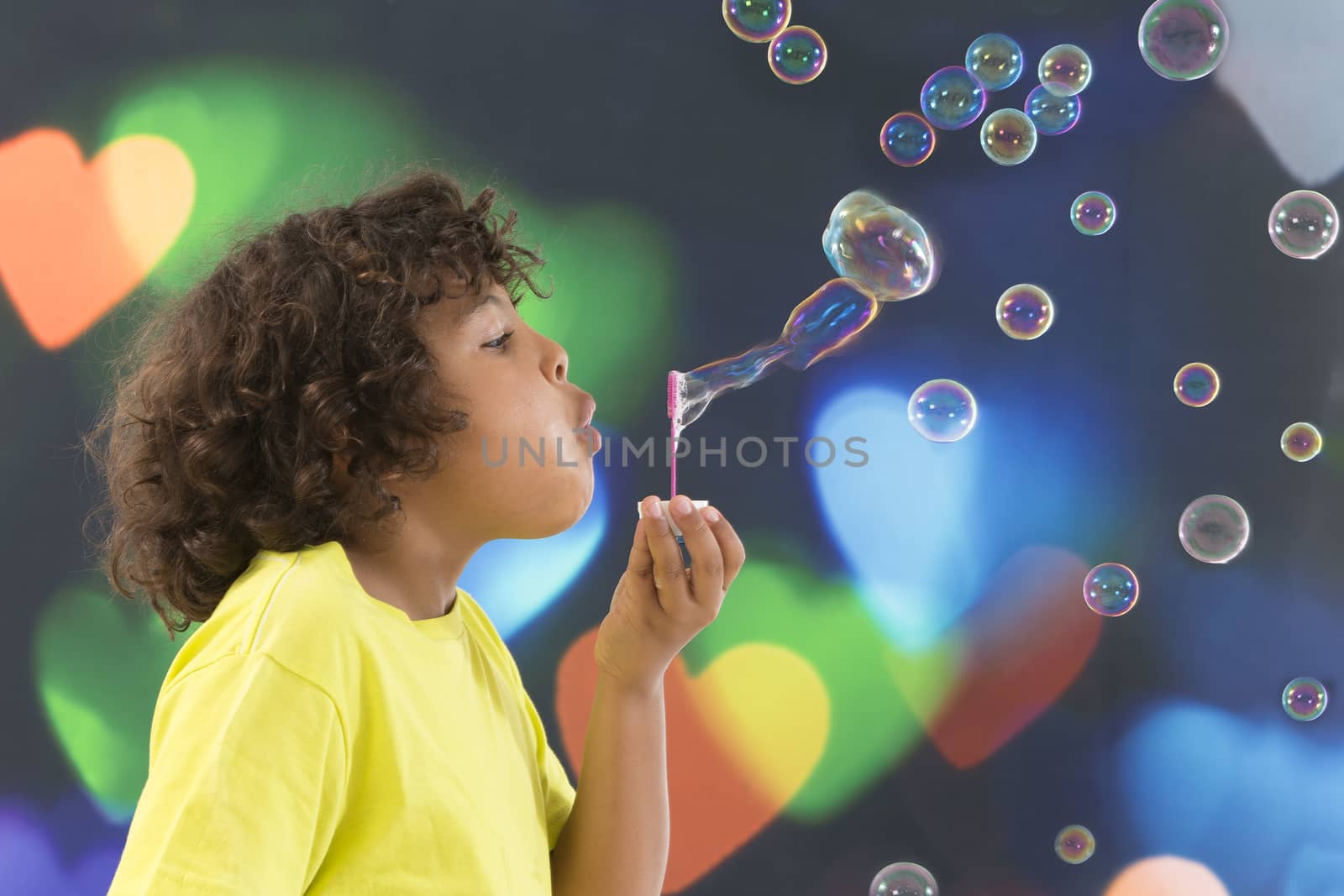 Boy blows up soap bubbles