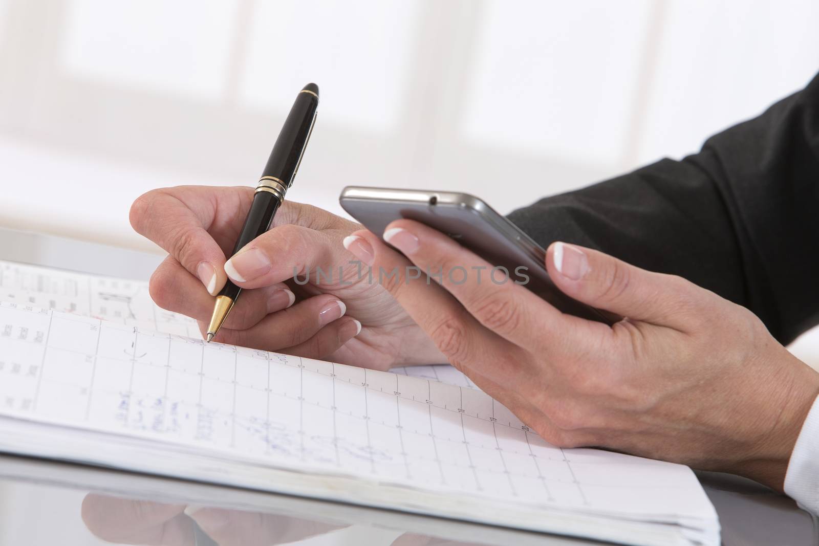 close up of female hand with pen, notebook and smart phone by JPC-PROD