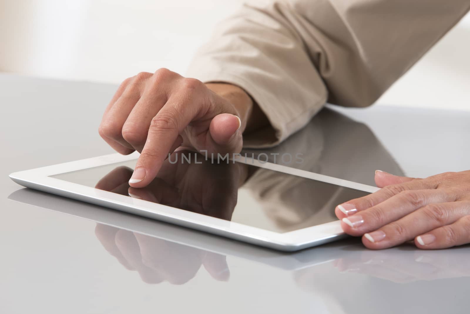 Hand of a woman using a digital tablet  by JPC-PROD
