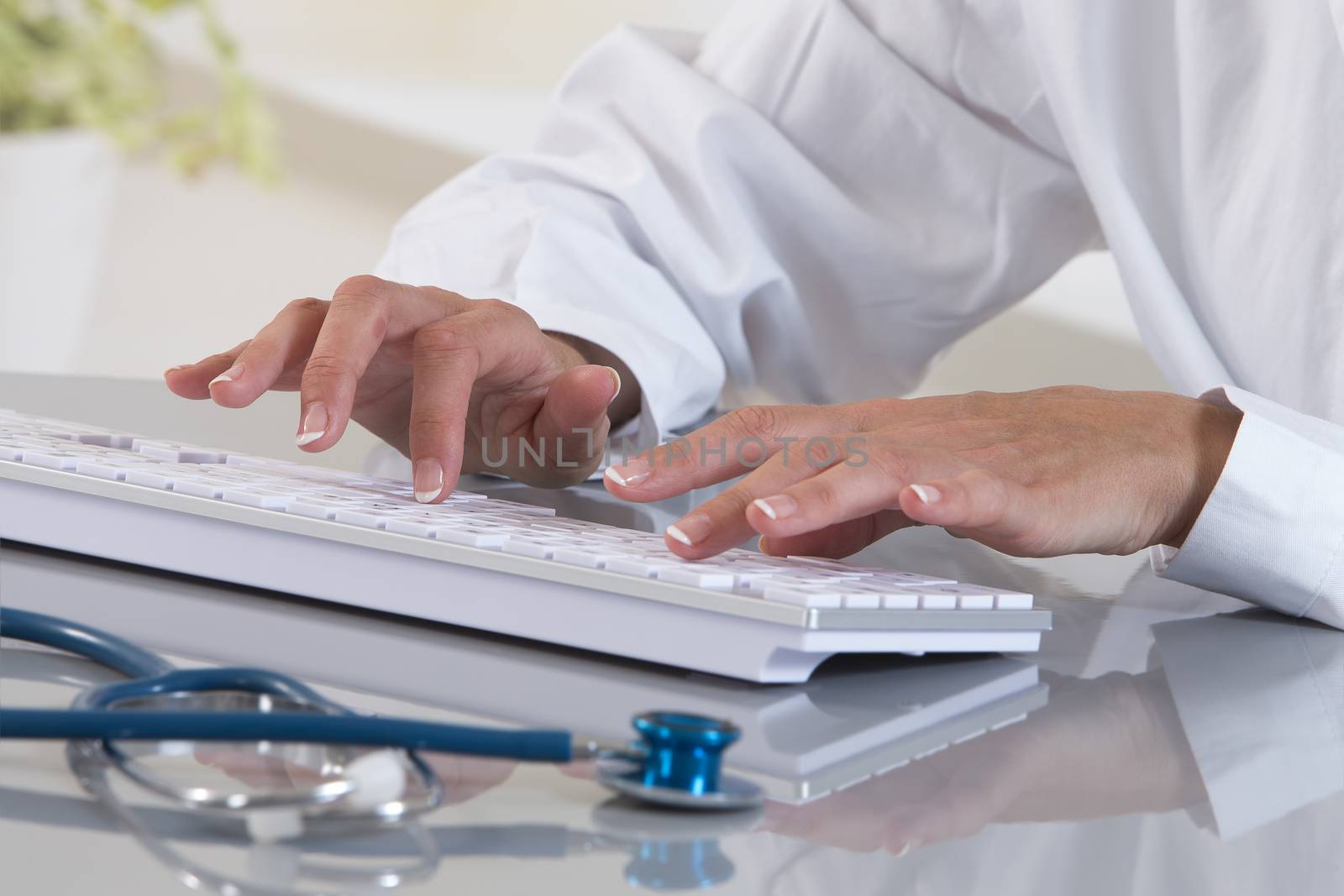 Close-up on hands of female medical doctor woman working at tabl by JPC-PROD