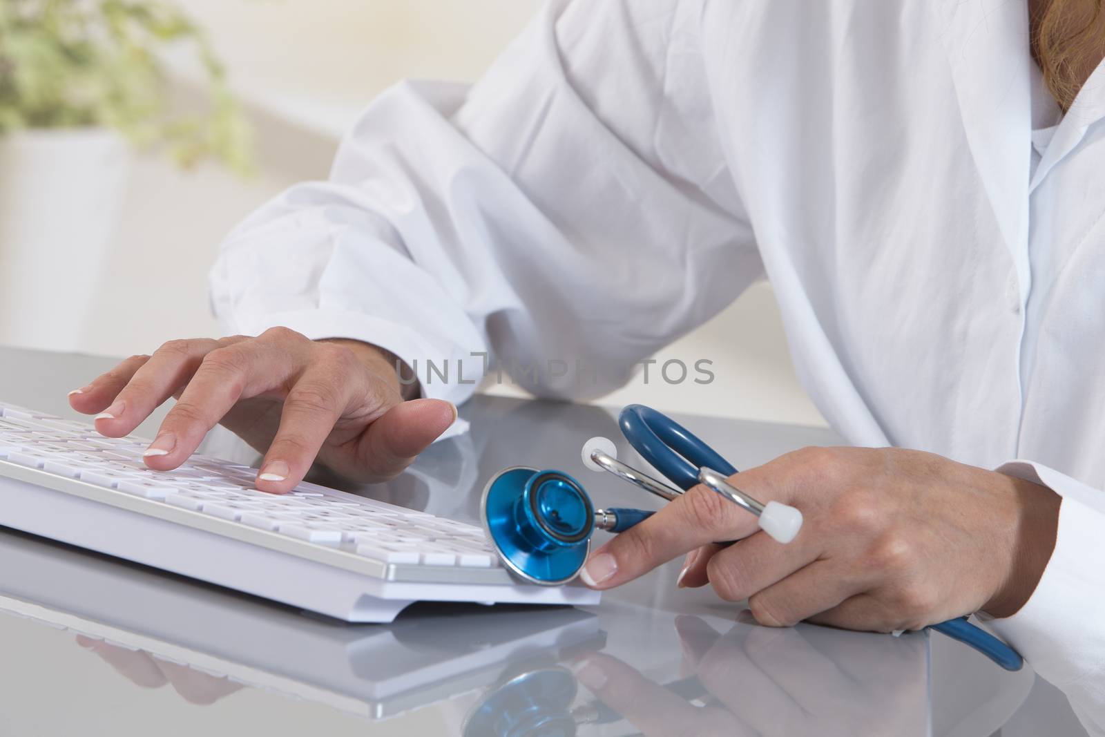 Close-up on hands of female medical doctor woman working at tabl by JPC-PROD
