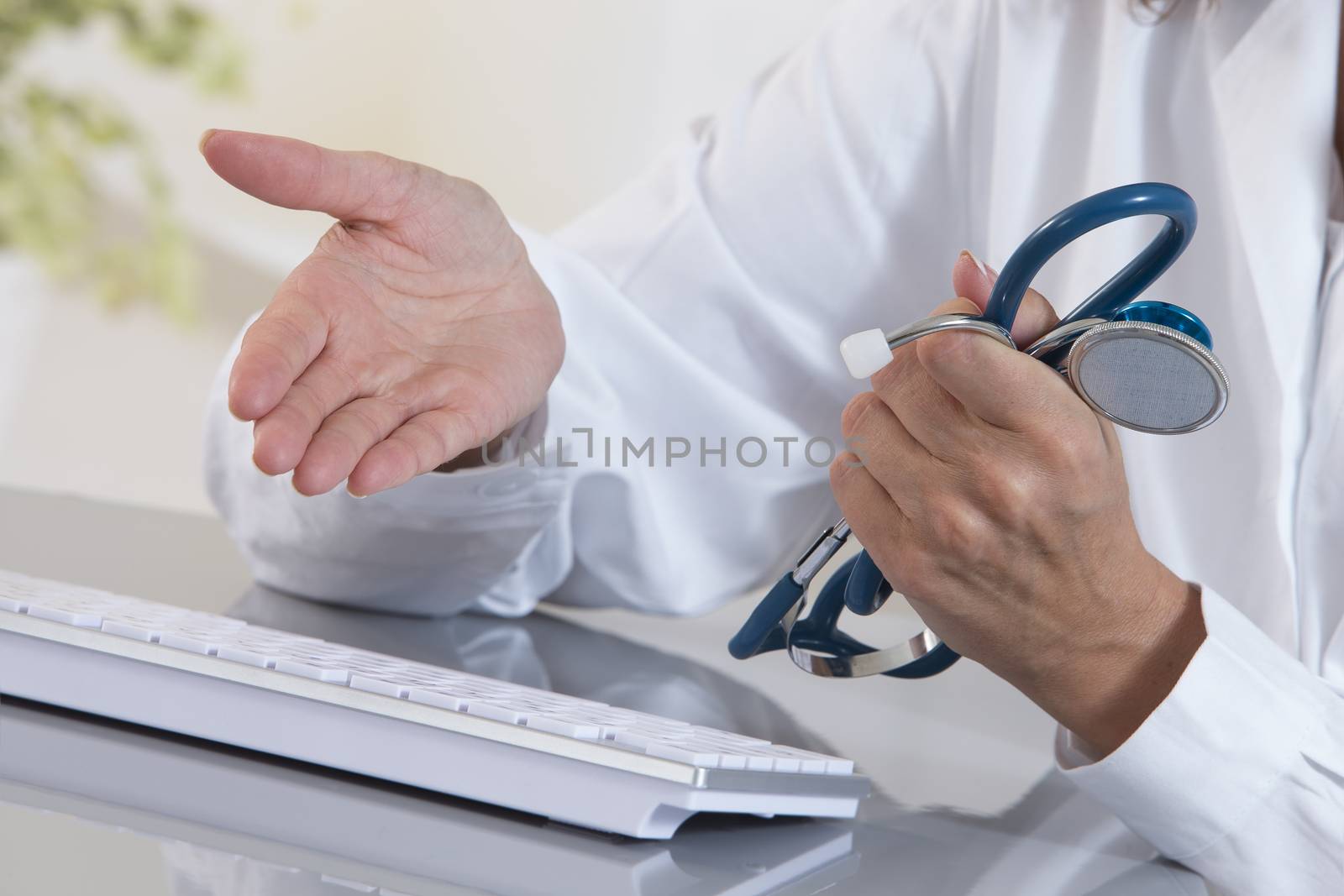 Close-up on hands of female medical doctor woman working at tabl by JPC-PROD