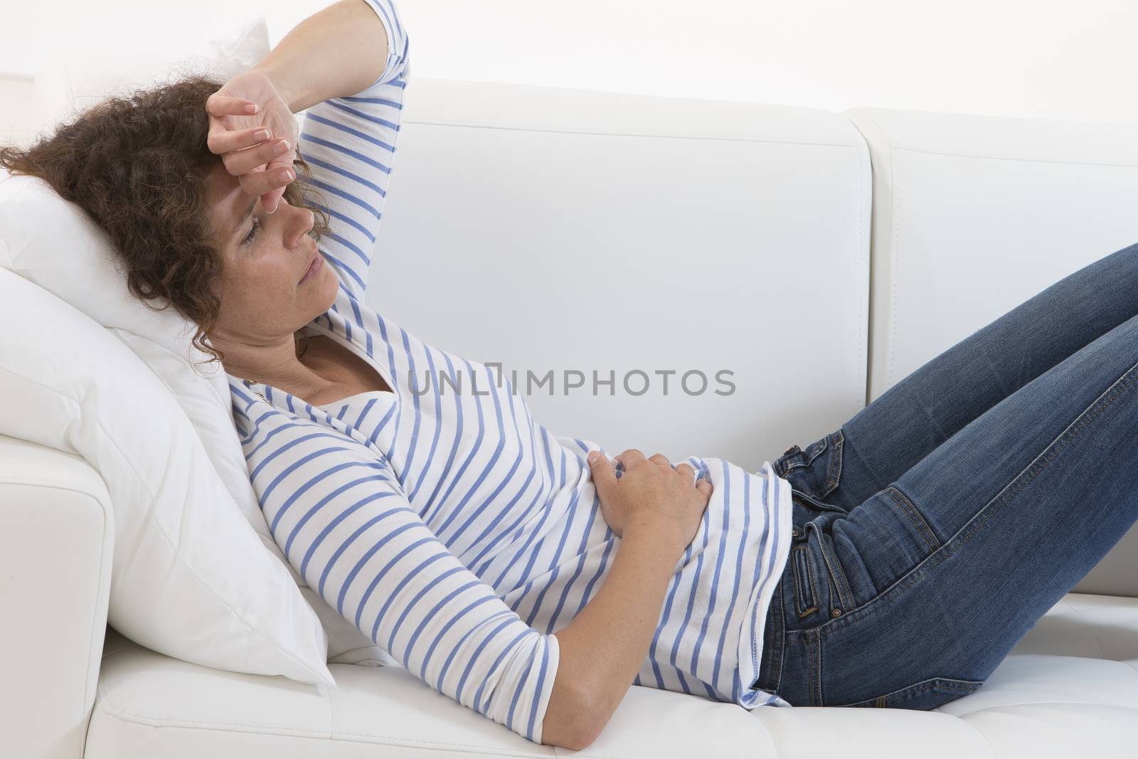 middle aged woman stroking her belly becouse of bellyache