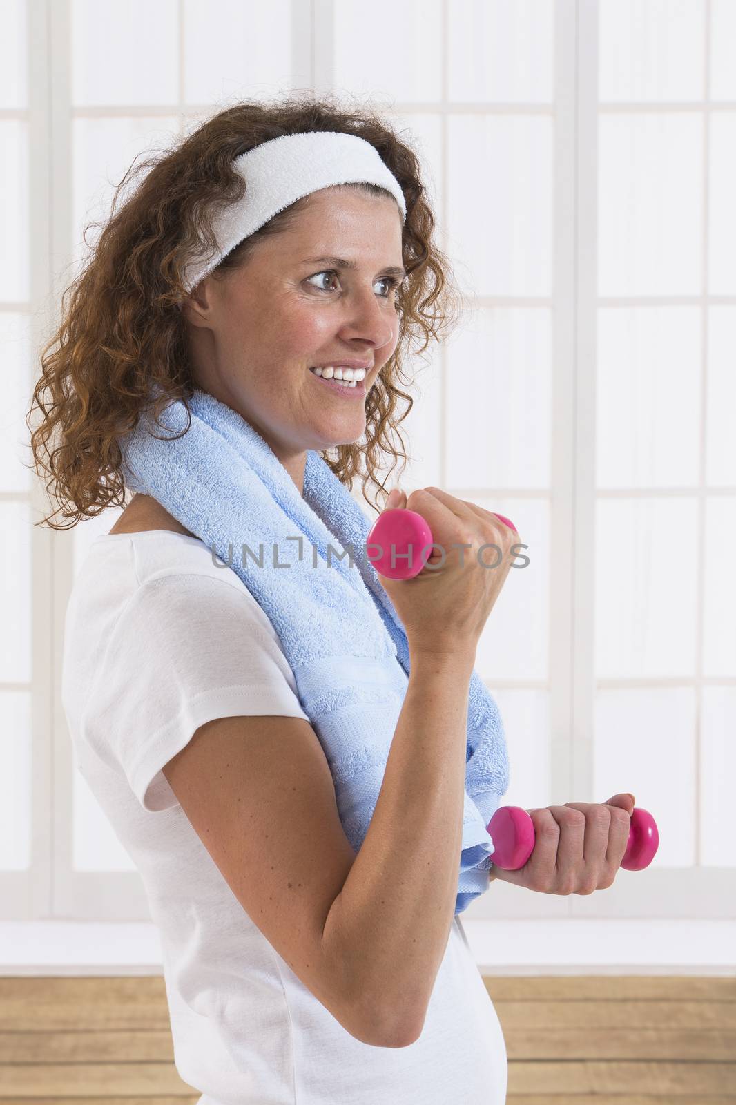 woman with weight training equipment on the gym