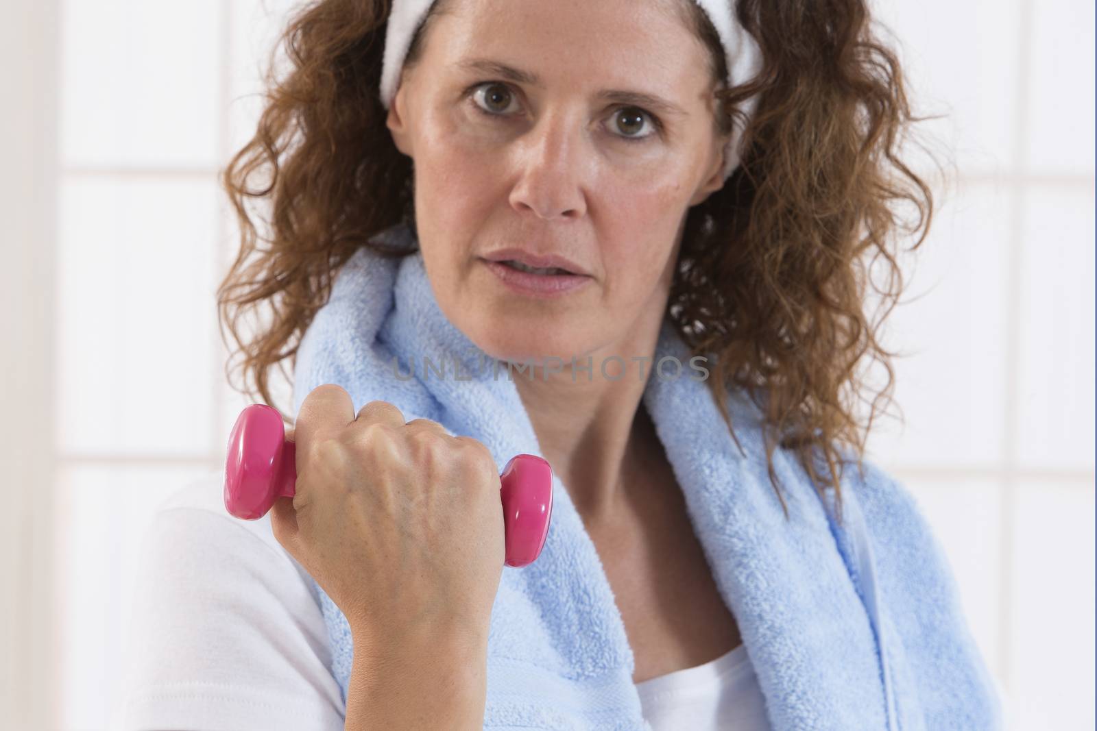 woman with weight training equipment on the gym