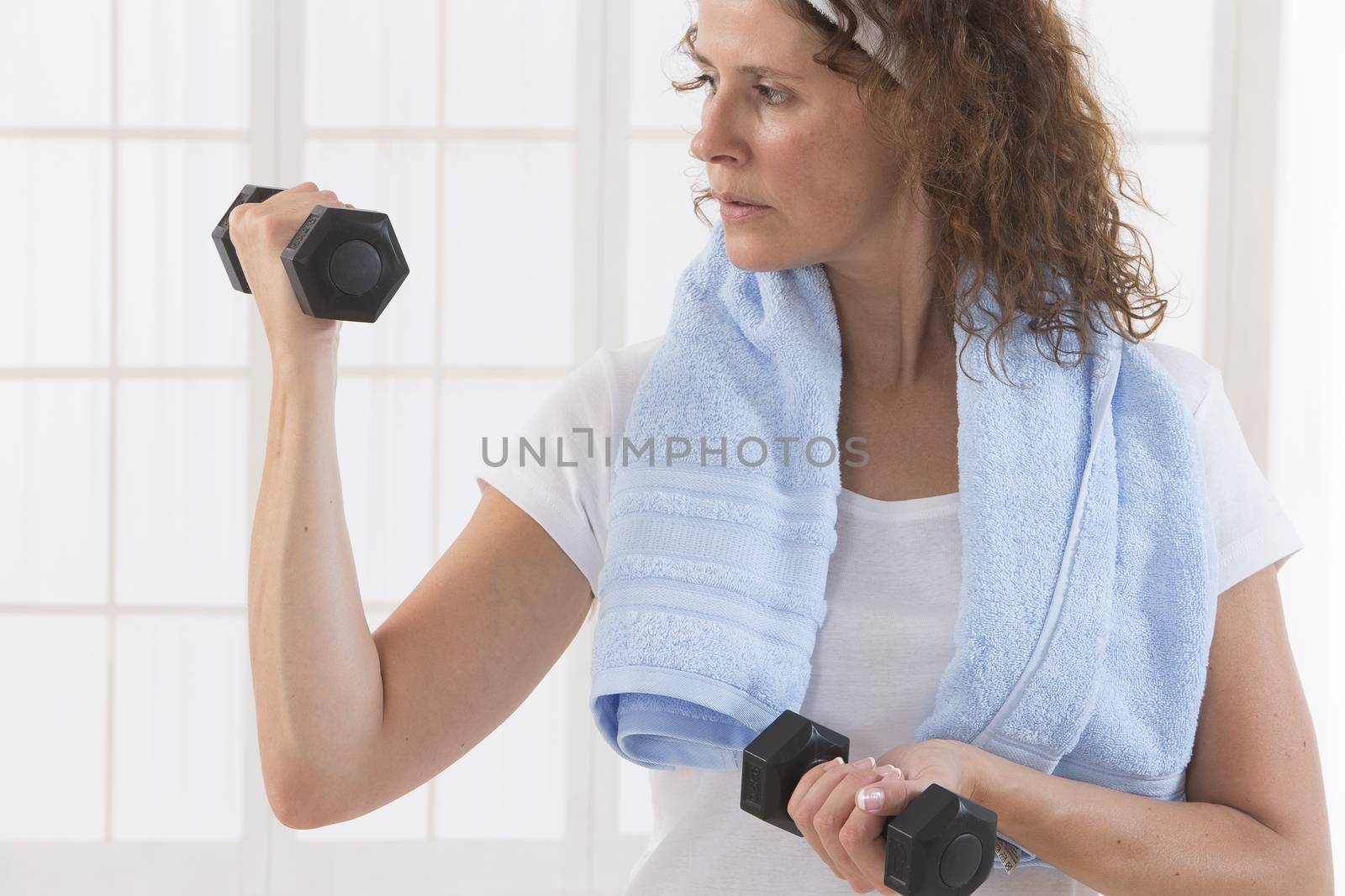 woman with weight training equipment on the gym