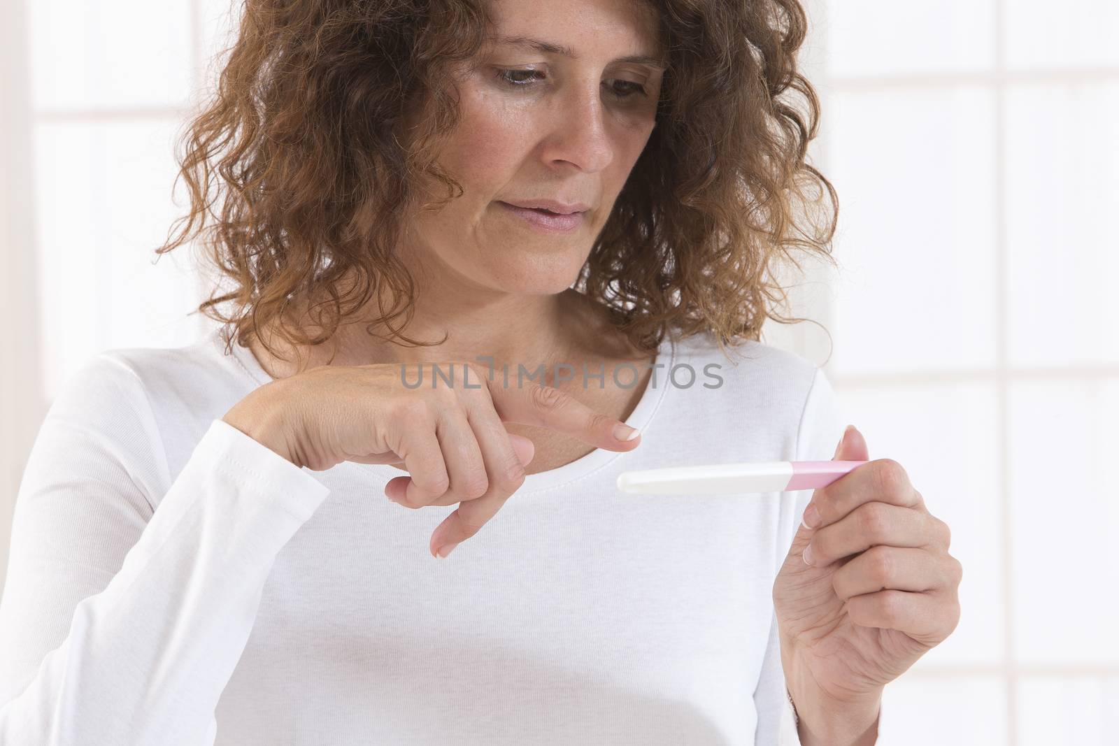 woman looking at pregnancy test by JPC-PROD