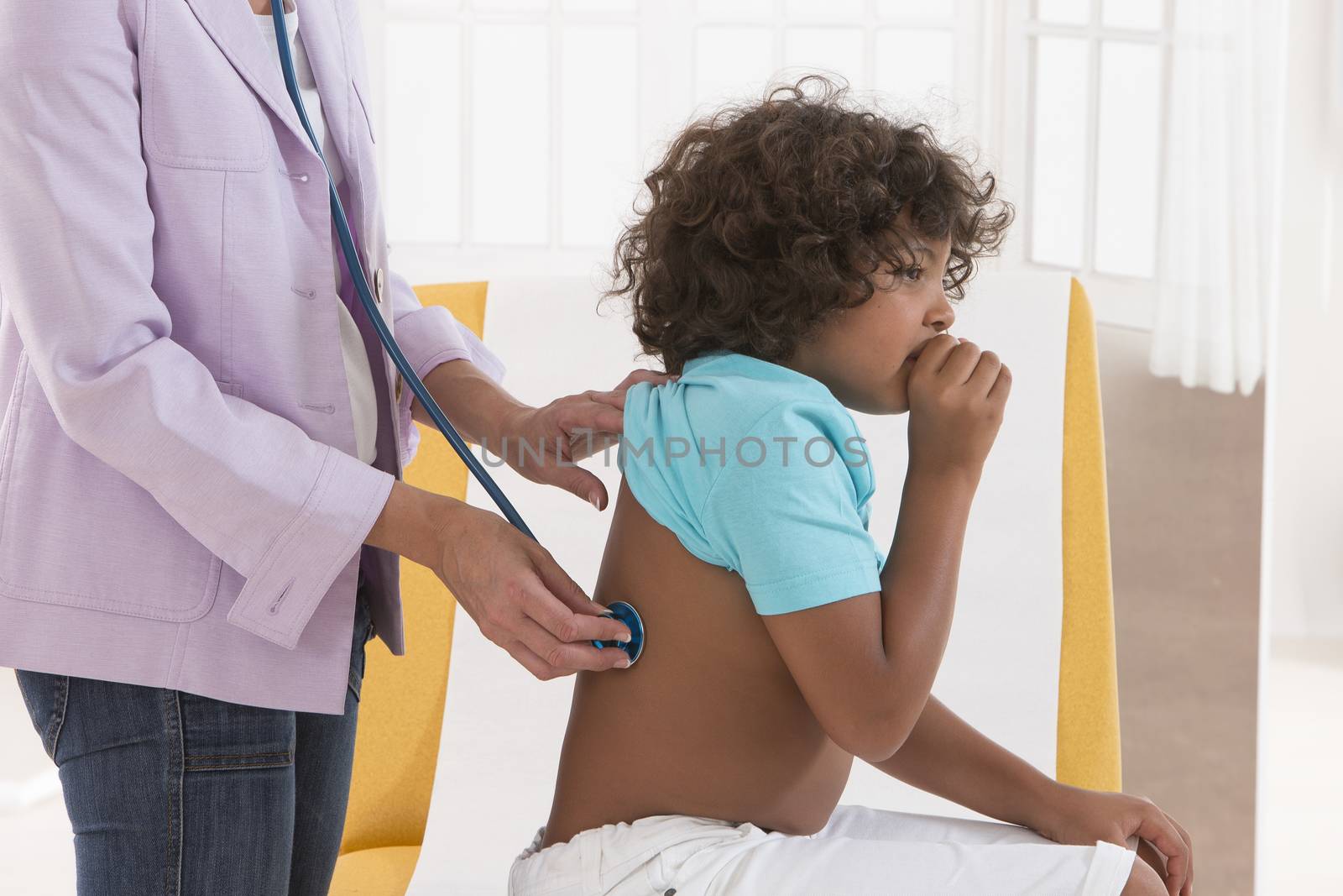 Closeup of female doctor checking patient lungs little boy with  by JPC-PROD