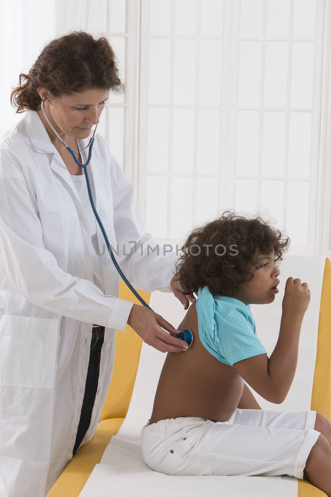 Closeup of female doctor checking patient lungs little boy with  by JPC-PROD