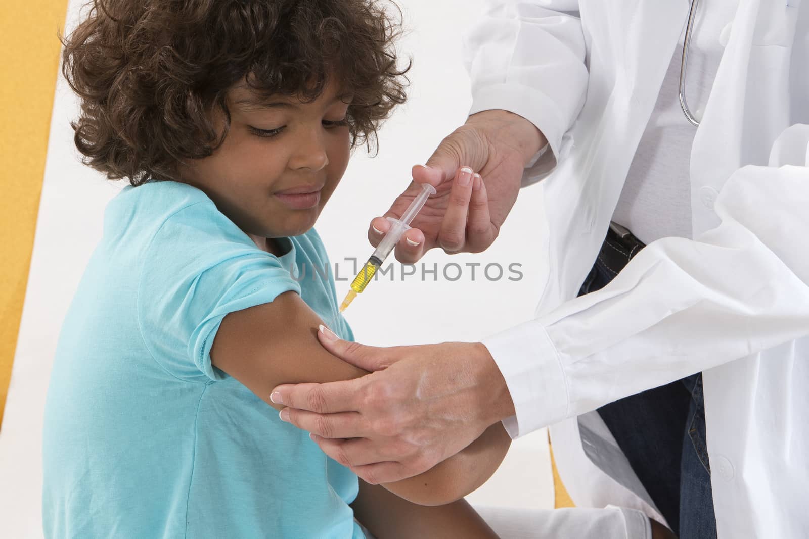 Doctor giving to a child an injection in examination room by JPC-PROD