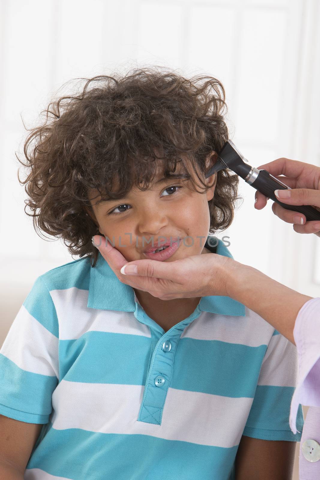 Little boy getting his ear checked