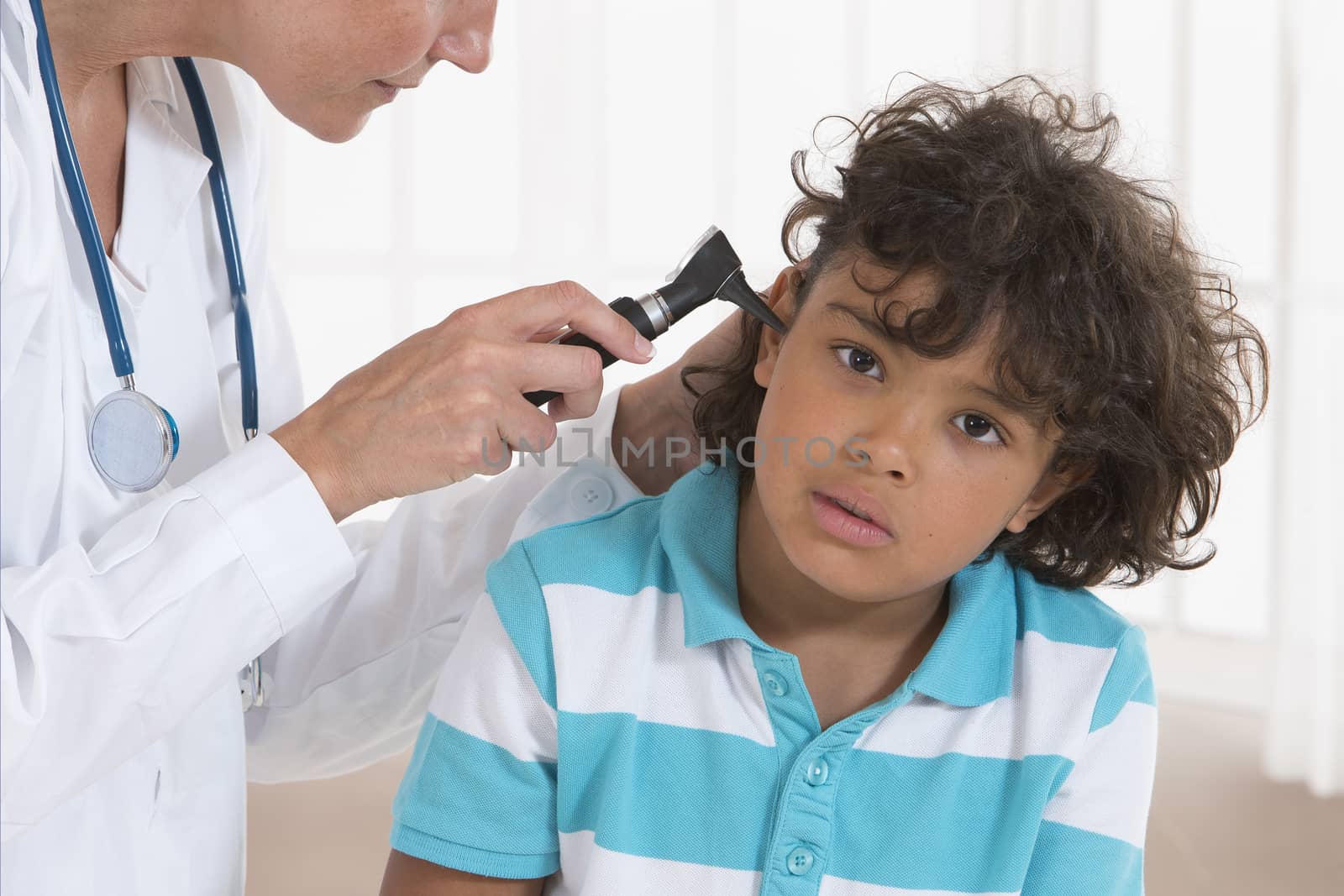 Little boy getting his ear checked