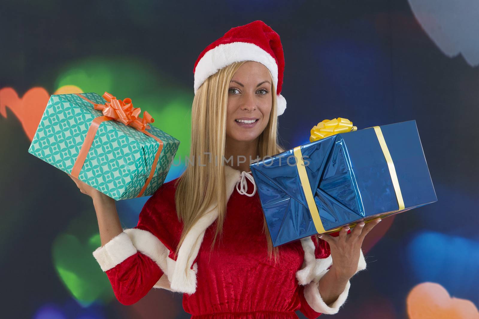 Beautiful young woman in Santa Claus clothes over with gifts on  by JPC-PROD