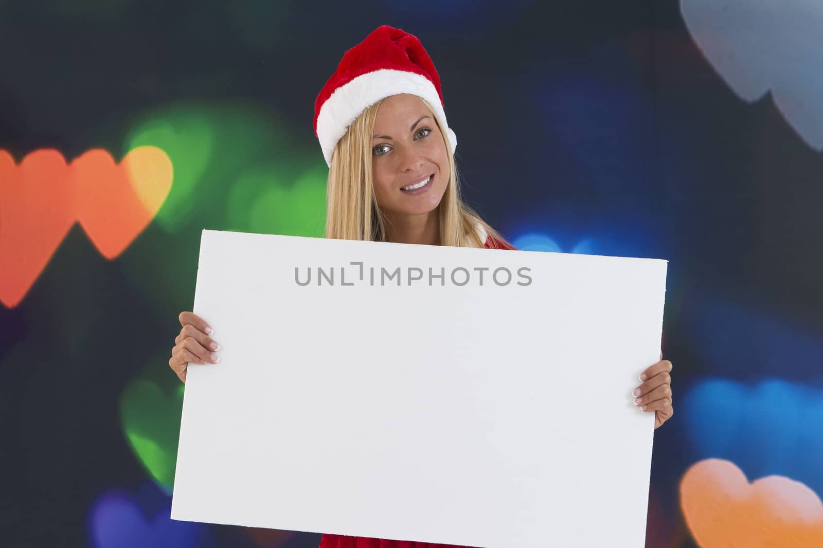 beautiful girl in red Santa Claus costume holding a blank board by JPC-PROD