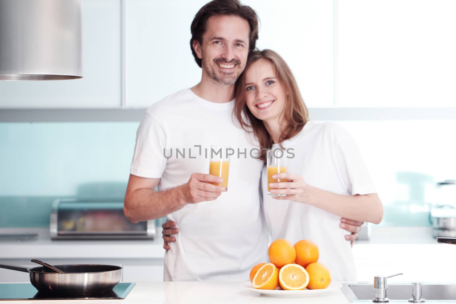 couple cooking breakfast at kitchen