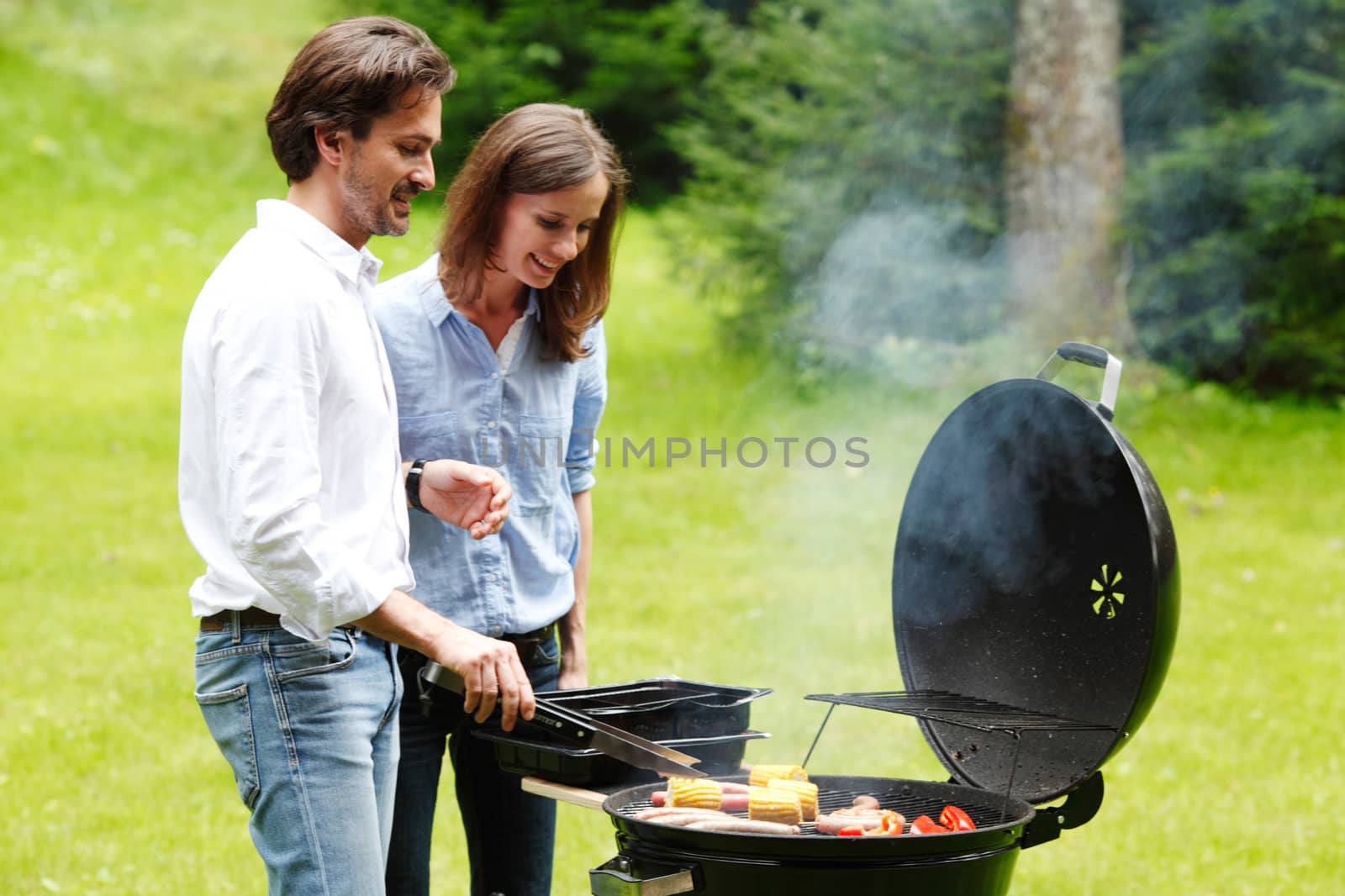 couple cooking outdoors by ALotOfPeople