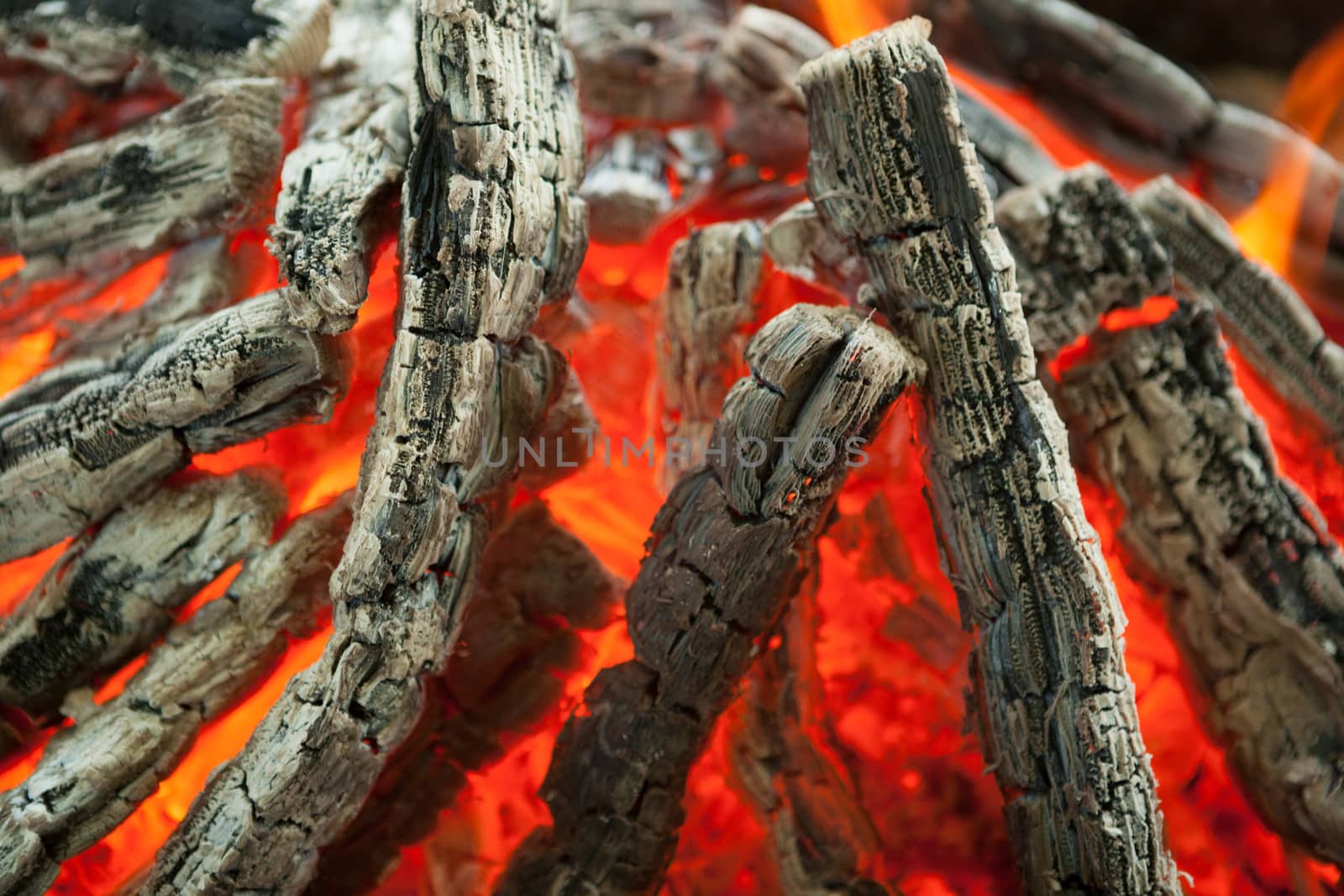Beautiful fire with flames charred wood by mcherevan