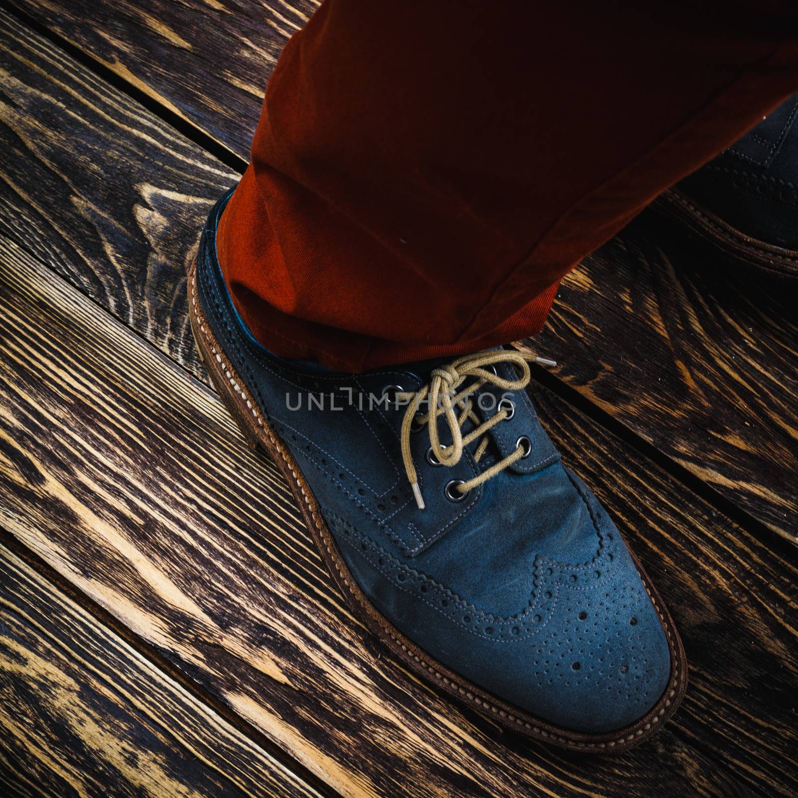 Close up of men's brogues (also known as derbies,gibsons or wingtips) made from blue oiled suede.