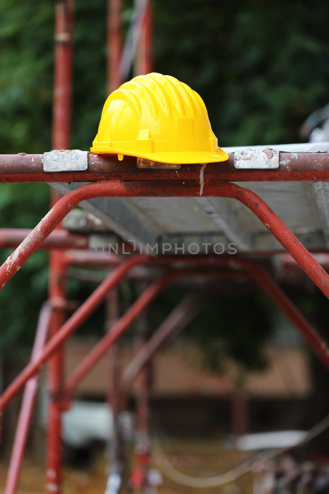 Yellow helmet on work place 