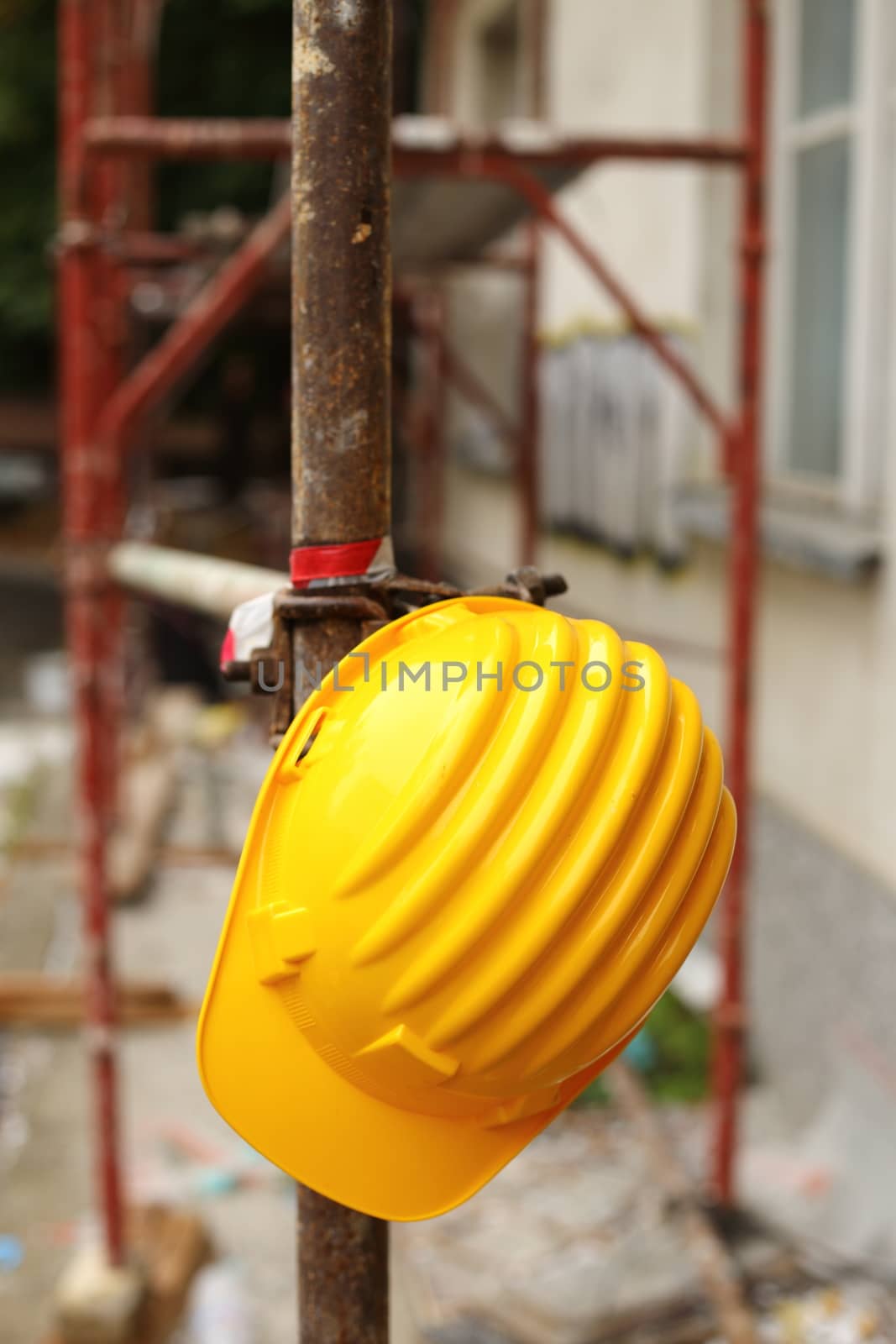 Yellow helmet on work place 