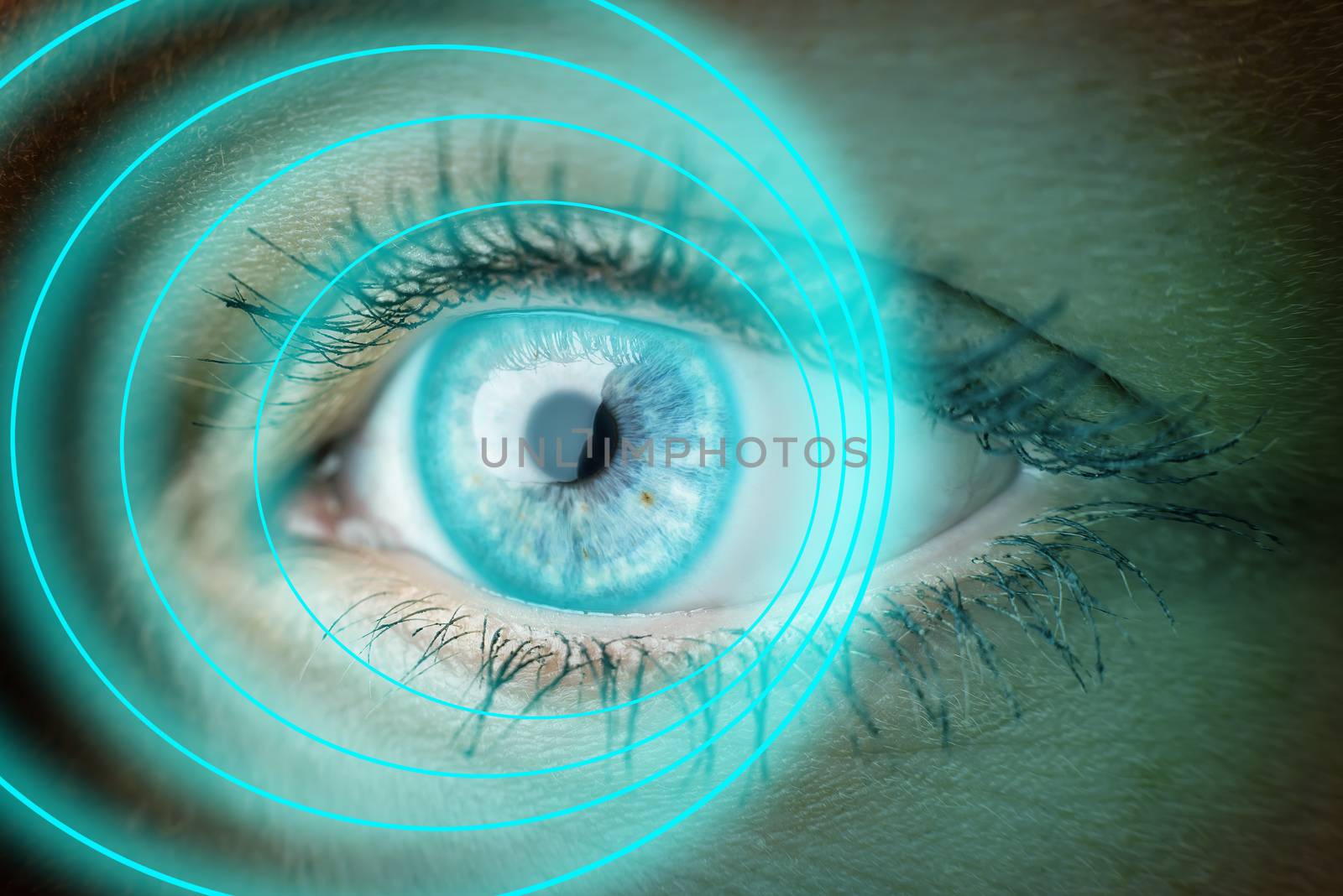 Closeup of the eye of a woman with blue glowing rings